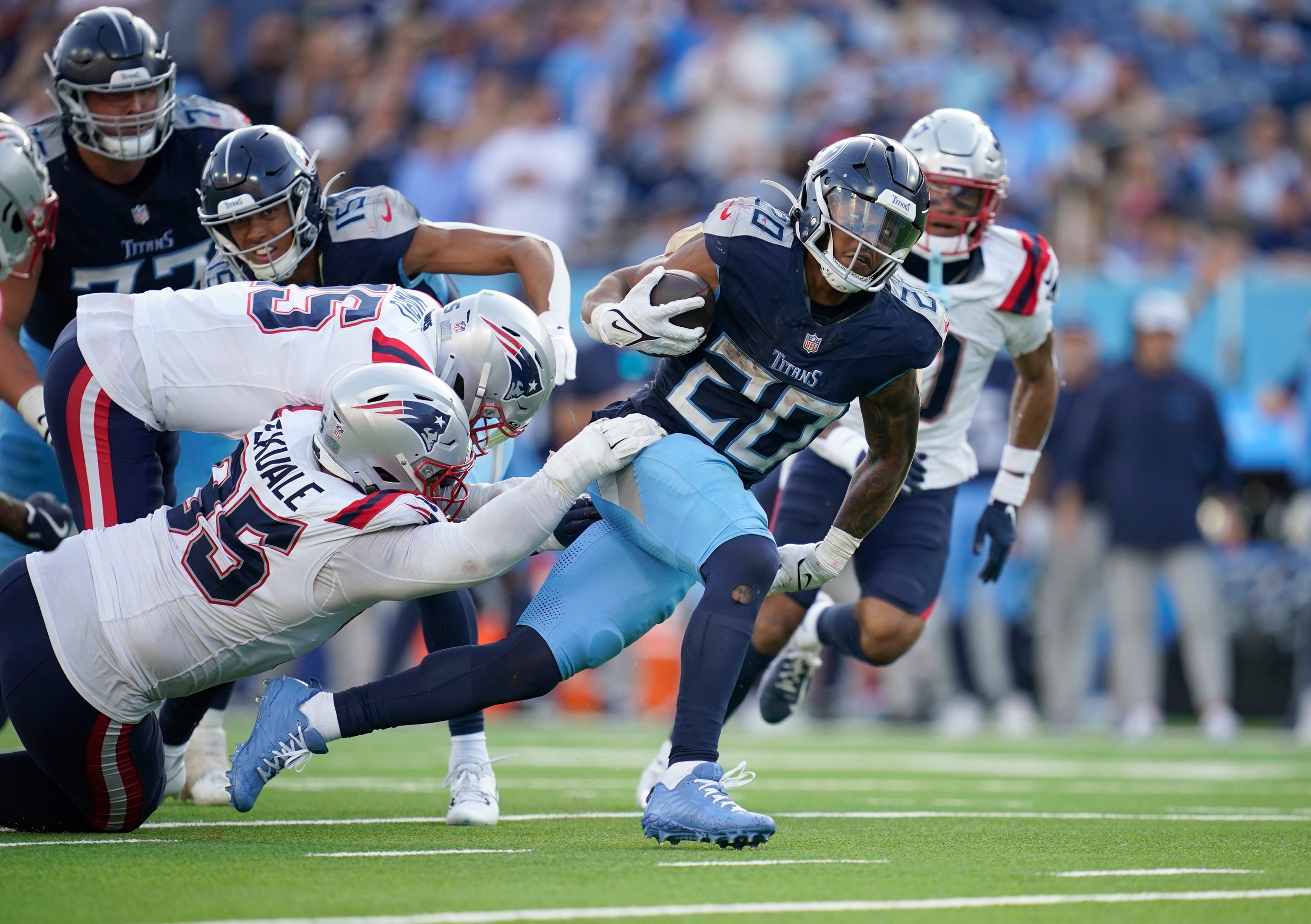 Tennessee Titans running back Tony Pollard (20) gets a first down past New England Patriots defensive tackle Daniel Ekuale (95) during overtime at Nissan Stadium in Nashville, Tenn., Sunday, Nov. 3, 2024.