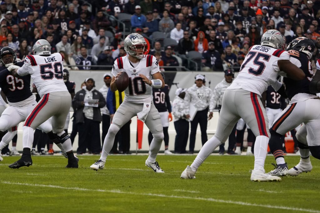 Nov 10, 2024; Chicago, Illinois, USA; New England Patriots quarterback Drake Maye (10) looks to [ass against the Chicago Bears during the first half at Soldier Field. Mandatory Credit: David Banks-Imagn Images