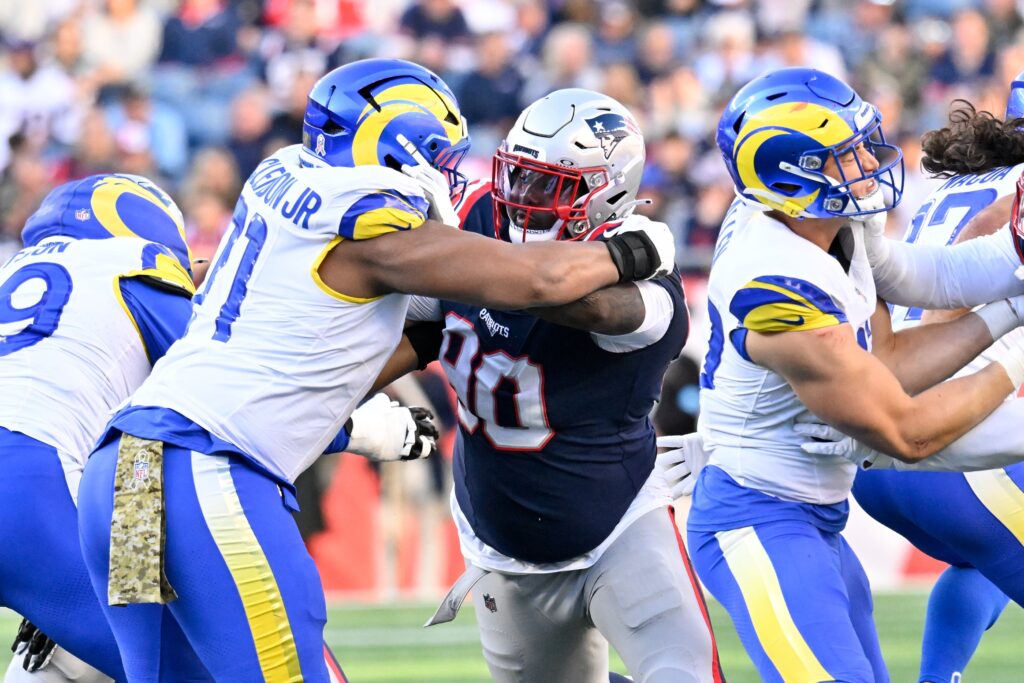 Nov 17, 2024; Foxborough, Massachusetts, USA; New England Patriots defensive tackle Christian Barmore (90) blocks Los Angeles Rams offensive tackle Warren McClendon Jr. (71) during the first half at Gillette Stadium. Mandatory Credit: Eric Canha-Imagn Images