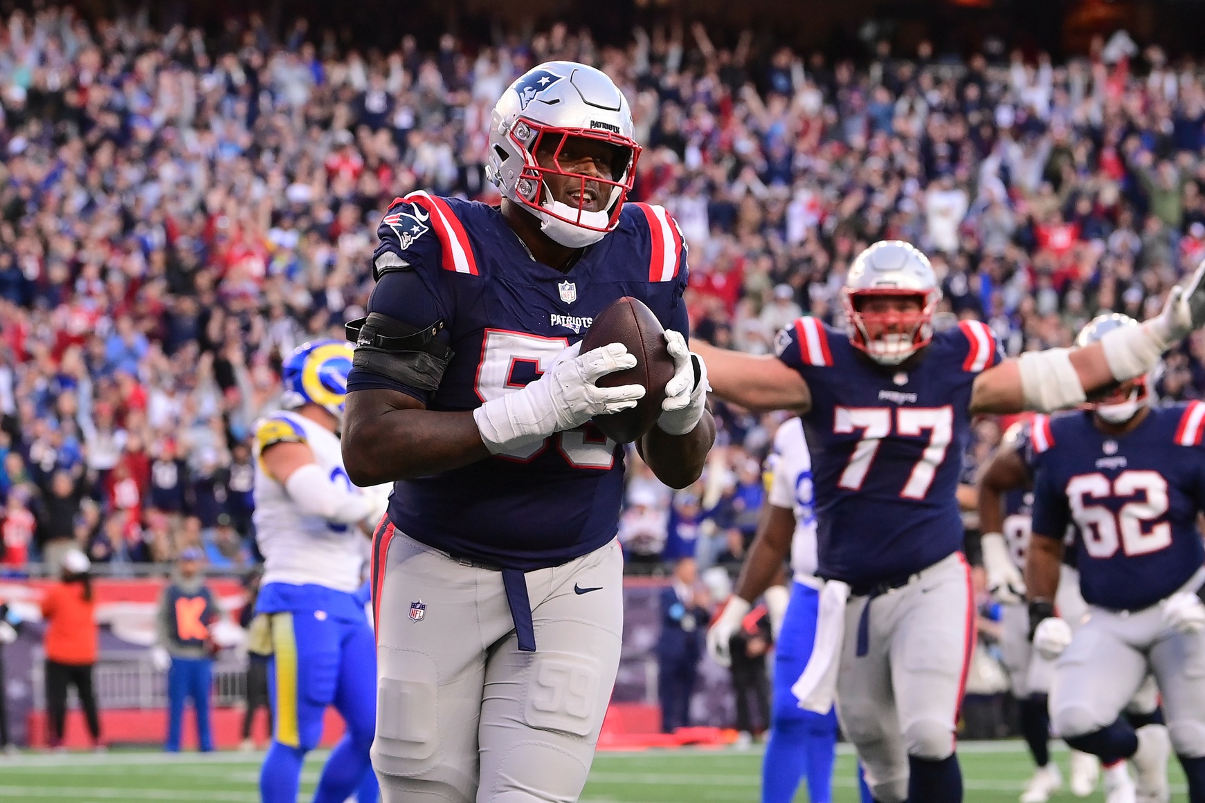 Nov 17, 2024; Foxborough, Massachusetts, USA;  New England Patriots offensive tackle Vederian Lowe (59) reacts to his touchdown against the Los Angeles Rams during the second half at Gillette Stadium. Mandatory Credit: Eric Canha-Imagn Images