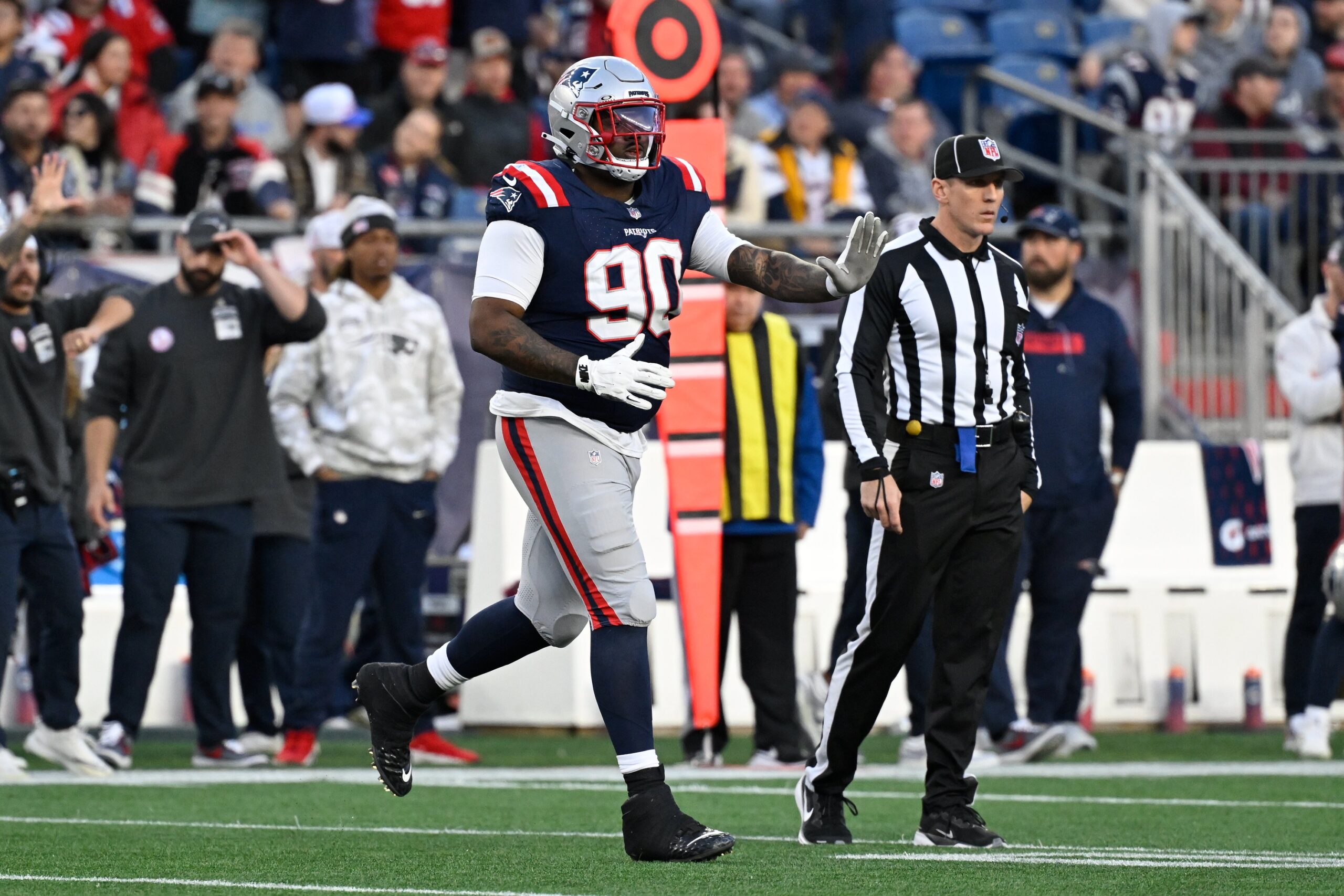 Nov 17, 2024; Foxborough, Massachusetts, USA;  New England Patriots defensive tackle Christian Barmore (90) runs onto the field during the second half against the Los Angeles Rams at Gillette Stadium. Mandatory Credit: Eric Canha-Imagn Images
