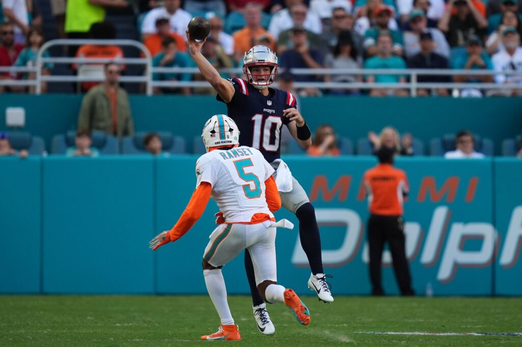 Nov 24, 2024; Miami Gardens, Florida, USA; New England Patriots quarterback Drake Maye (10) attempts a pass over Miami Dolphins cornerback Jalen Ramsey (5) during the second half at Hard Rock Stadium. Mandatory Credit: Jasen Vinlove-Imagn Images