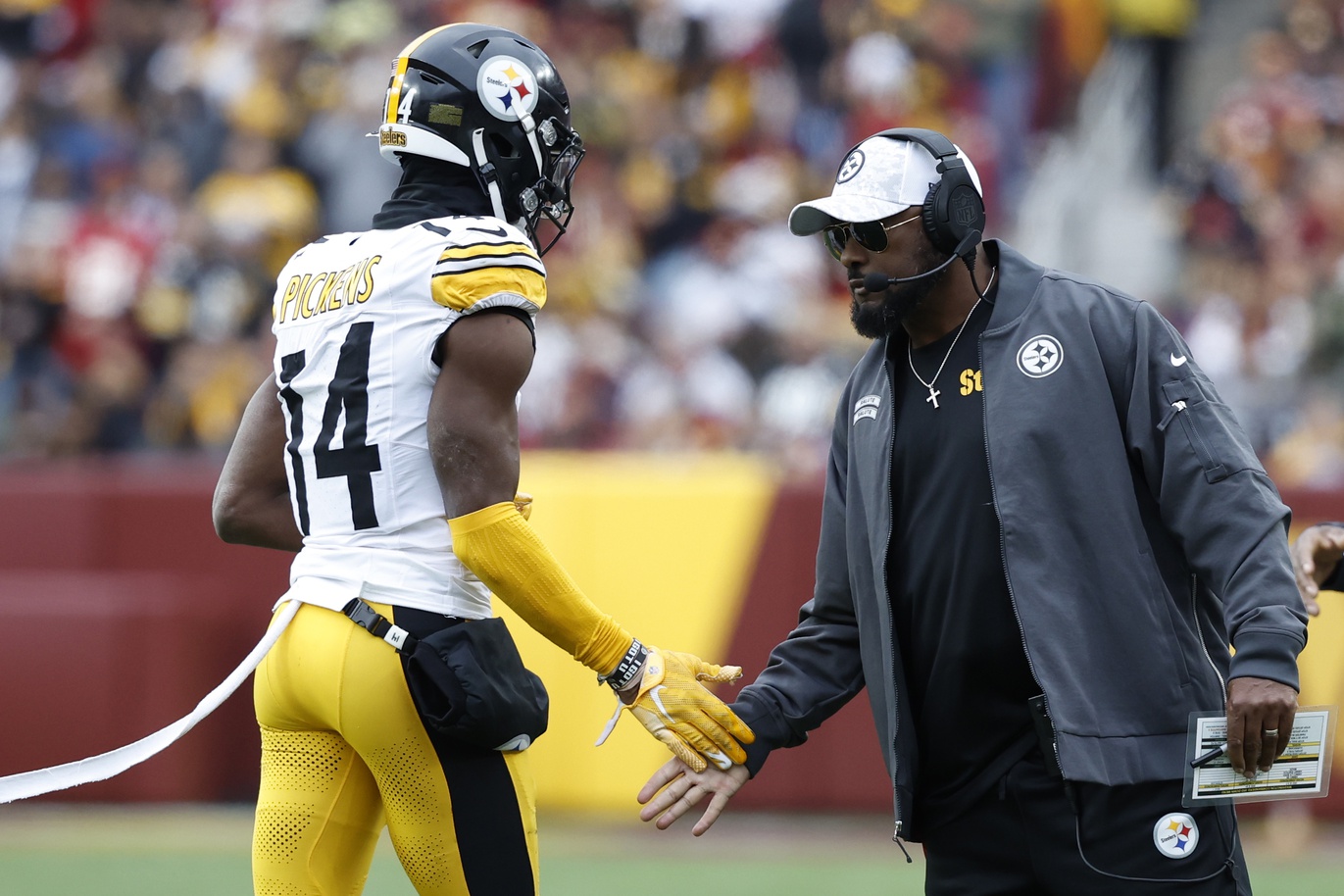 Nov 10, 2024; Landover, Maryland, USA; Pittsburgh Steelers head coach Mike Tomlin (R) congratulates Steelers wide receiver George Pickens (14) after a long catch against the Washington Commanders during the second half at Northwest Stadium. Mandatory Credit: Geoff Burke-Imagn Images