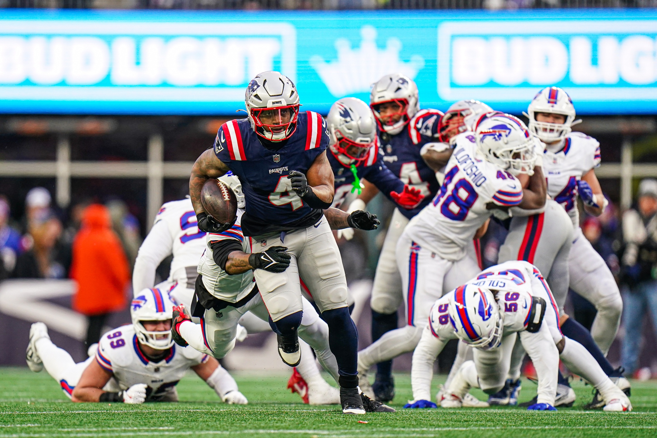 Jan 5, 2025; Foxborough, Massachusetts, USA; New England Patriots running back Antonio Gibson (4) runs the ball against the Buffalo Bills in the second half at Gillette Stadium. Mandatory Credit: David Butler II-Imagn Images