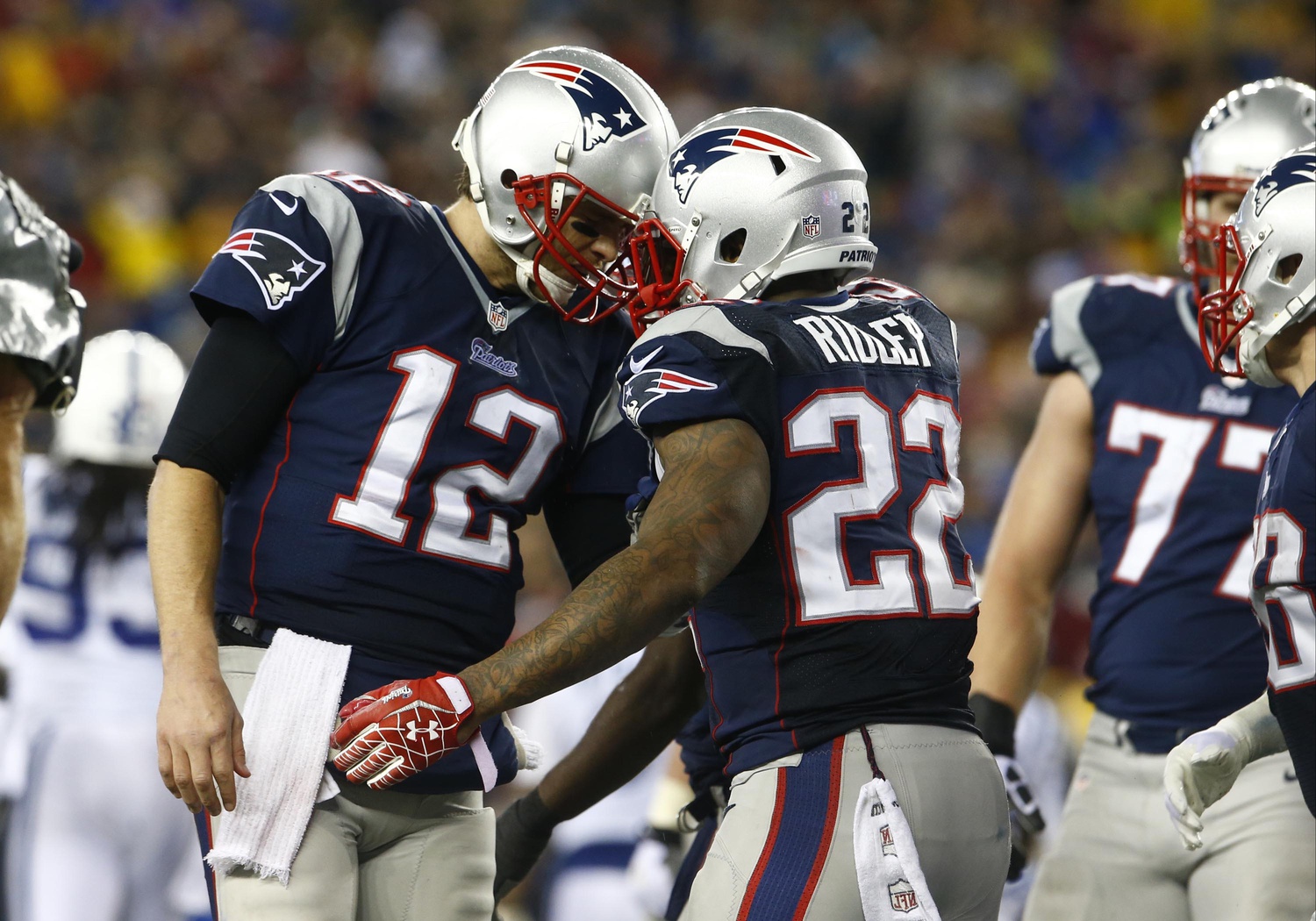 Jan 11, 2014; Foxborough, MA, USA; New England Patriots running back Stevan Ridley (22) celebrates with quarterback Tom Brady (12) after a touchdown in the second half during the 2013 AFC divisional playoff football game against the Indianapolis Colts at Gillette Stadium. Mandatory Credit: David Butler II-USA TODAY Sports