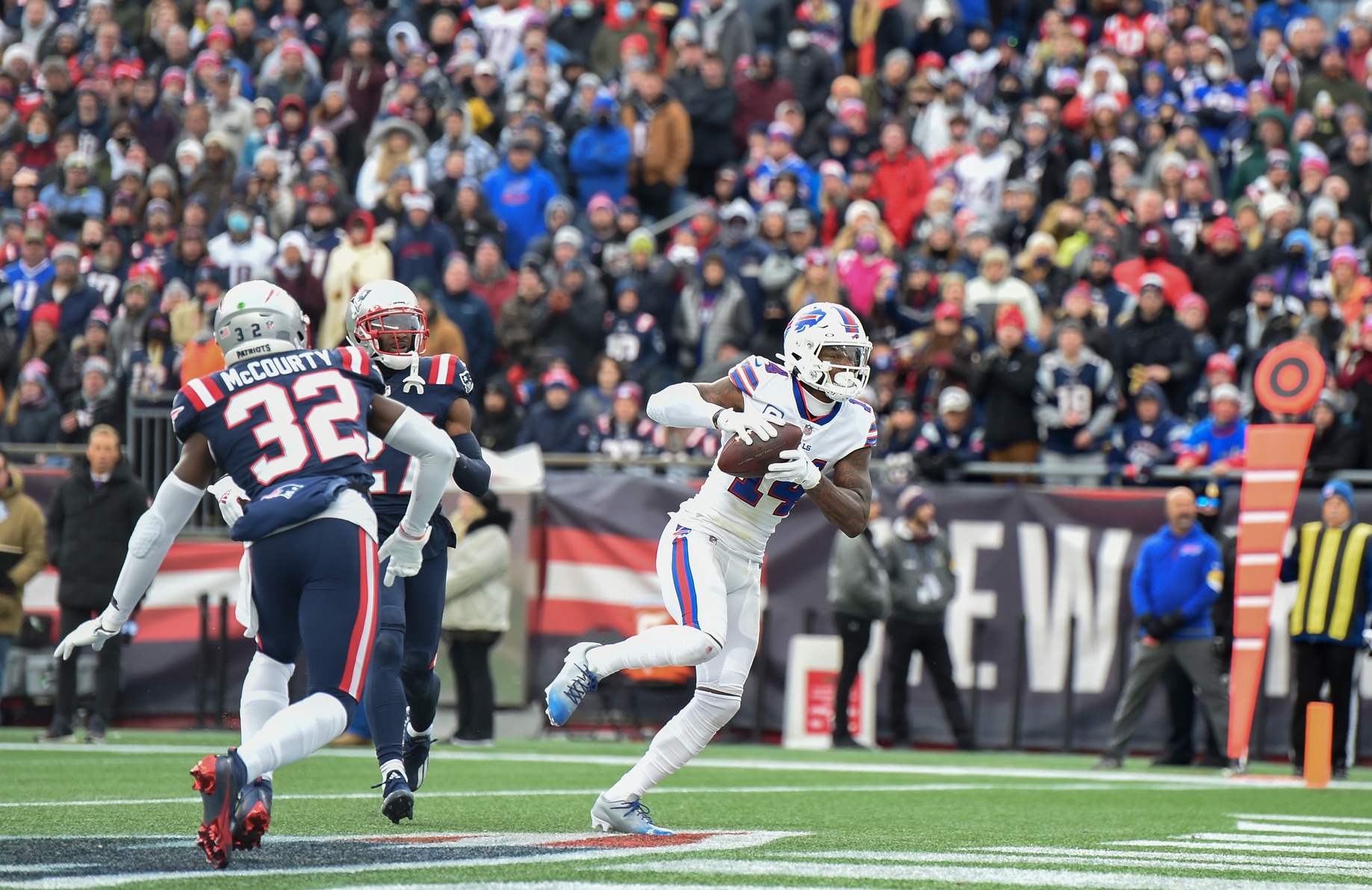 Dec 26, 2021; Foxborough, Massachusetts, USA; Buffalo Bills wide receiver Stefon Diggs (14) catches a pass for a touchdown as New England Patriots free safety Devin McCourty (32) looks on during the first half at Gillette Stadium. Mandatory Credit: Bob DeChiara-USA TODAY Sports