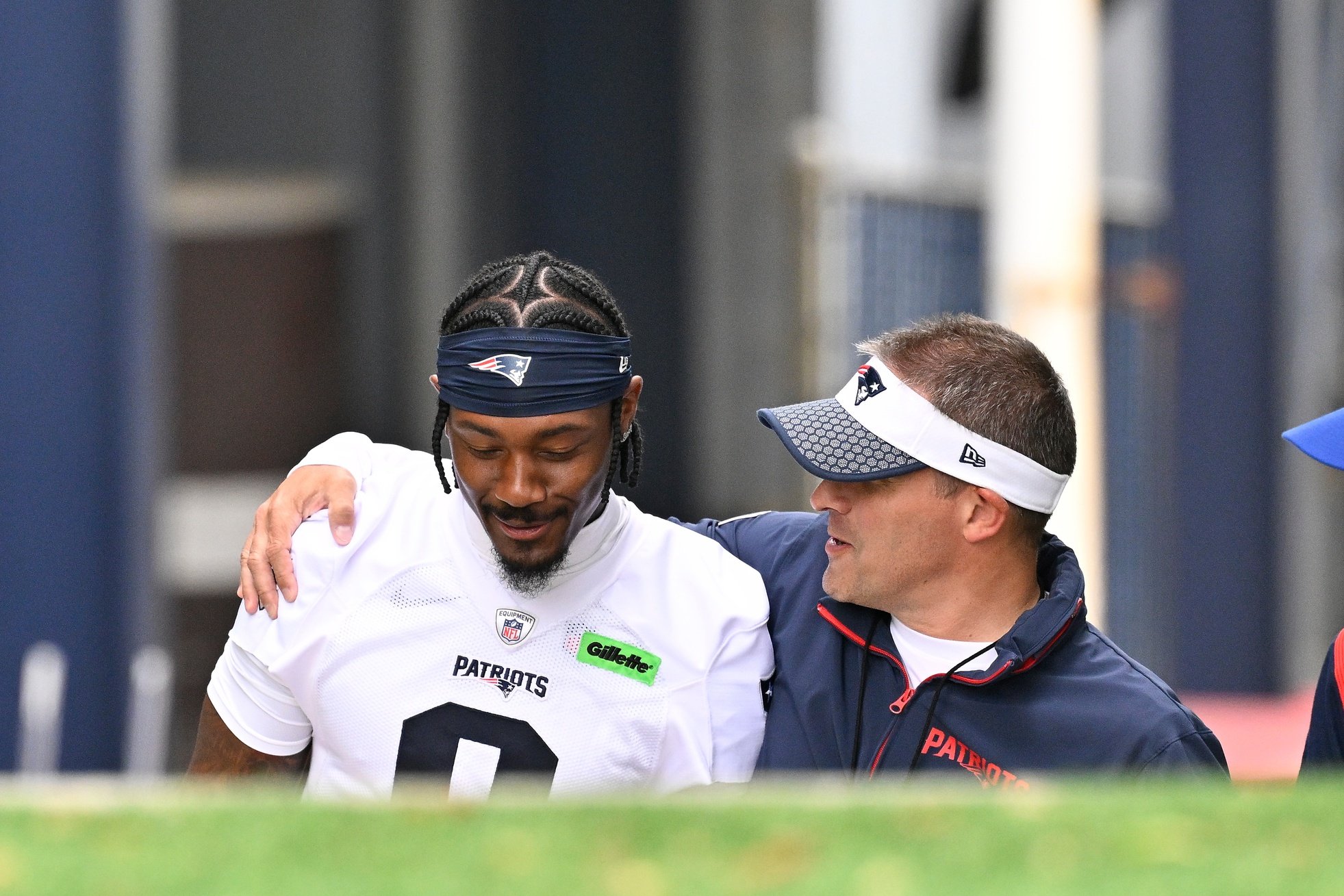 Jun 9, 2025; Foxborough, MA, USA; New England Patriots offensive coordinator Josh McDaniels (r) walks to the practice field with his arm around wide receiver Stefon Diggs (8) before  minicamp at Gillette Stadium. Mandatory Credit: Eric Canha-Imagn Images