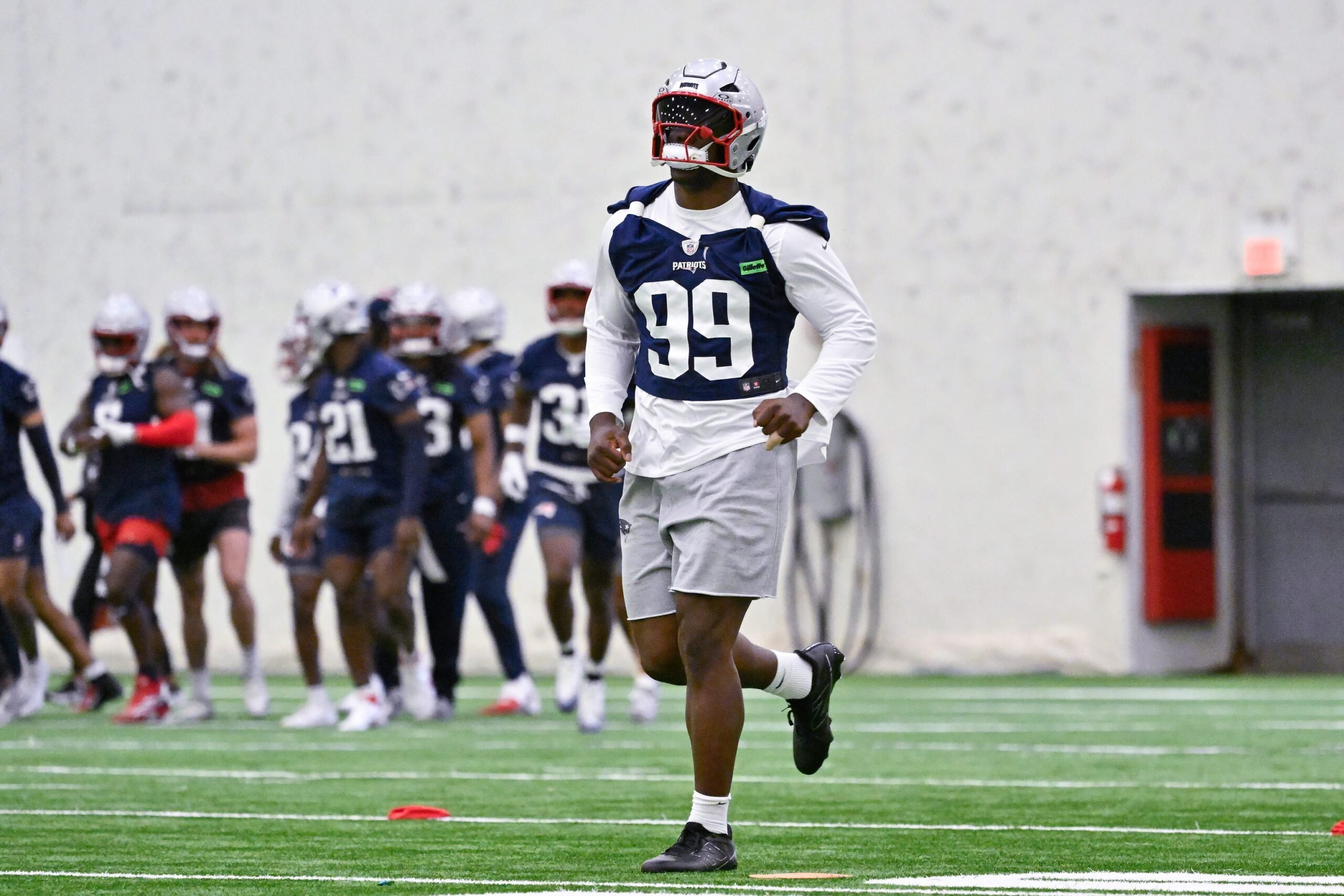 Jun 10, 2025; Foxborough, MA, USA; New England Patriots defensive end Keion White (99) warms up during minicamp held in the WIN Field House at Gillette Stadium. Mandatory Credit: Eric Canha-Imagn Images
