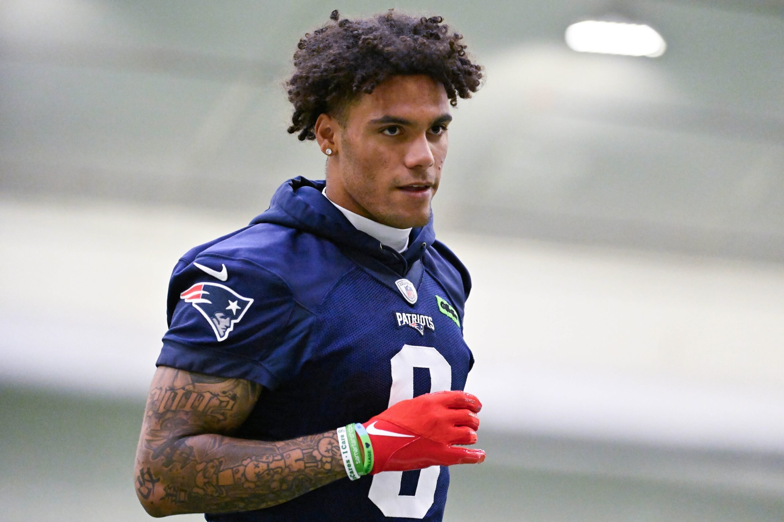 Jun 10, 2025; Foxborough, MA, USA; New England Patriots cornerback Christian Gonzalez (0) jogs to the sideline during minicamp held in the WIN Field House at Gillette Stadium. Mandatory Credit: Eric Canha-Imagn Images