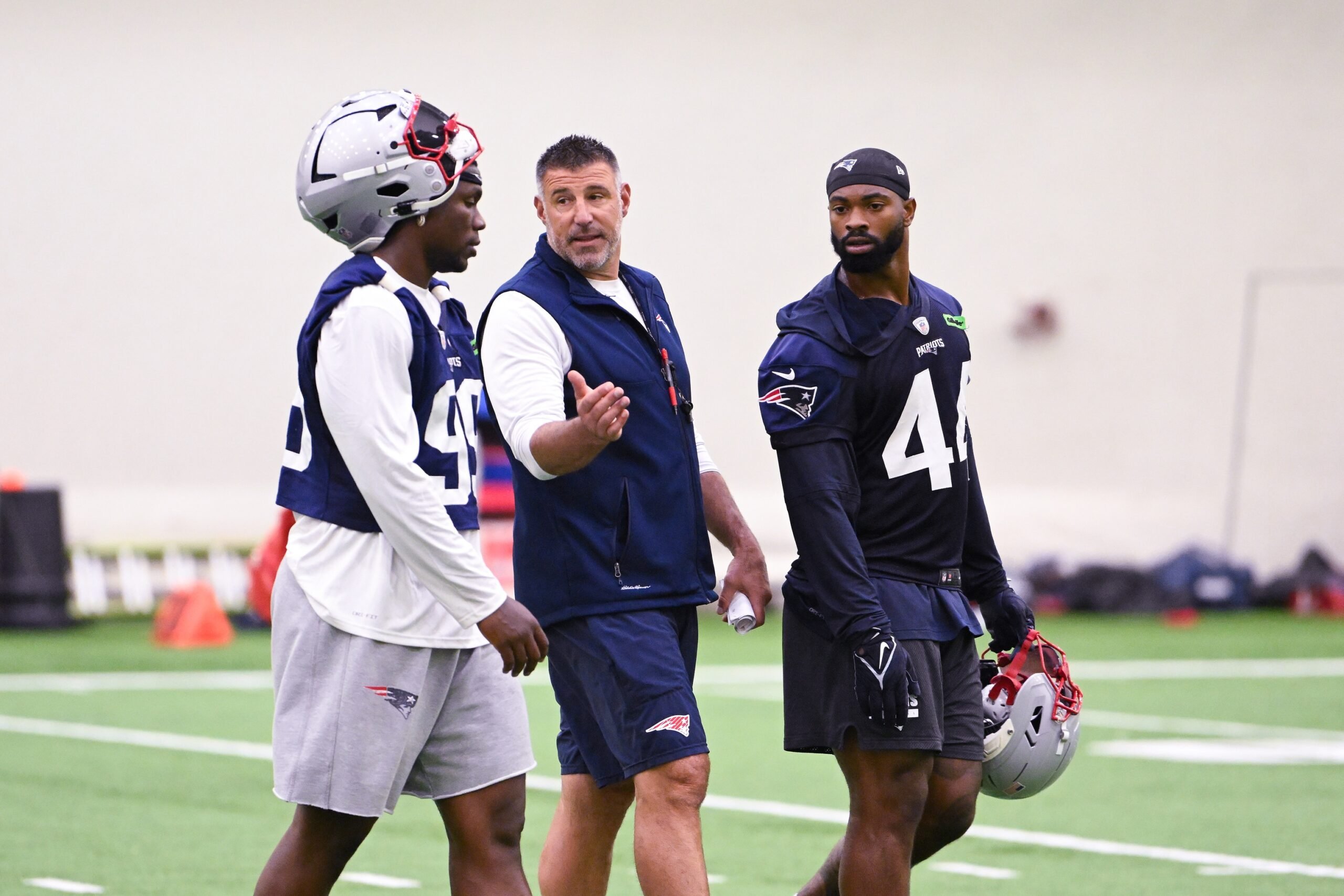 Jun 10, 2025; Foxborough, MA, USA; New England Patriots head coach Mike Vrabel speaks to defensive end Keion White (99) and linebacker K'Lavon Chaisson (44) after minicamp held in the WIN Field House at Gillette Stadium. Mandatory Credit: Eric Canha-Imagn Images