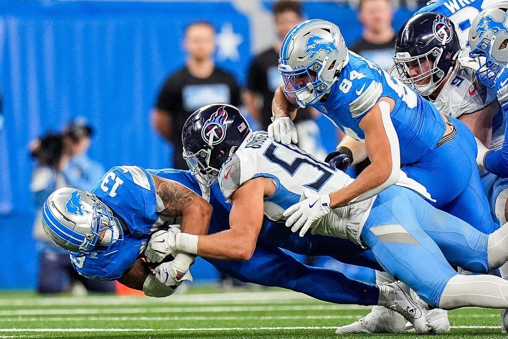 Detroit Lions running back Craig Reynolds (13) runs against Tennessee Titans linebacker Jack Gibbens (50) during the second half at Ford Field in Detroit on Sunday, Oct. 27, 2024.