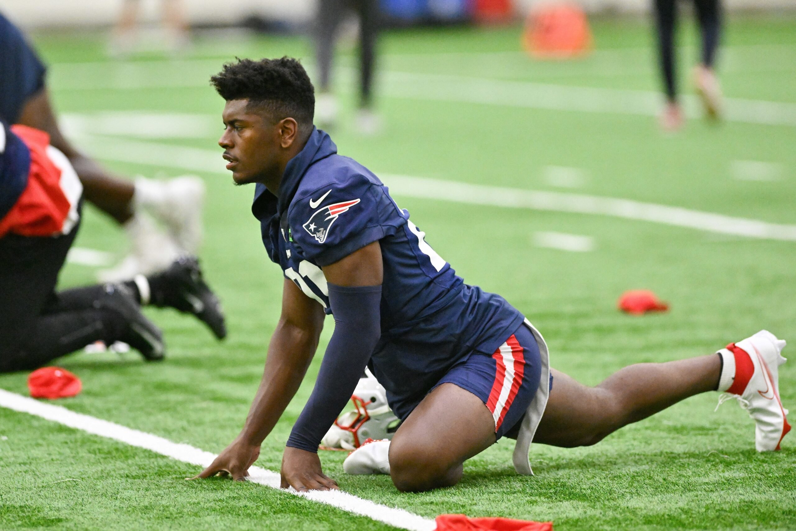 Jun 10, 2025; Foxborough, MA, USA; New England Patriots safety Jaylinn Hawkins (21)  stretches during minicamp held in the WIN Field House at Gillette Stadium. Mandatory Credit: Eric Canha-Imagn Images