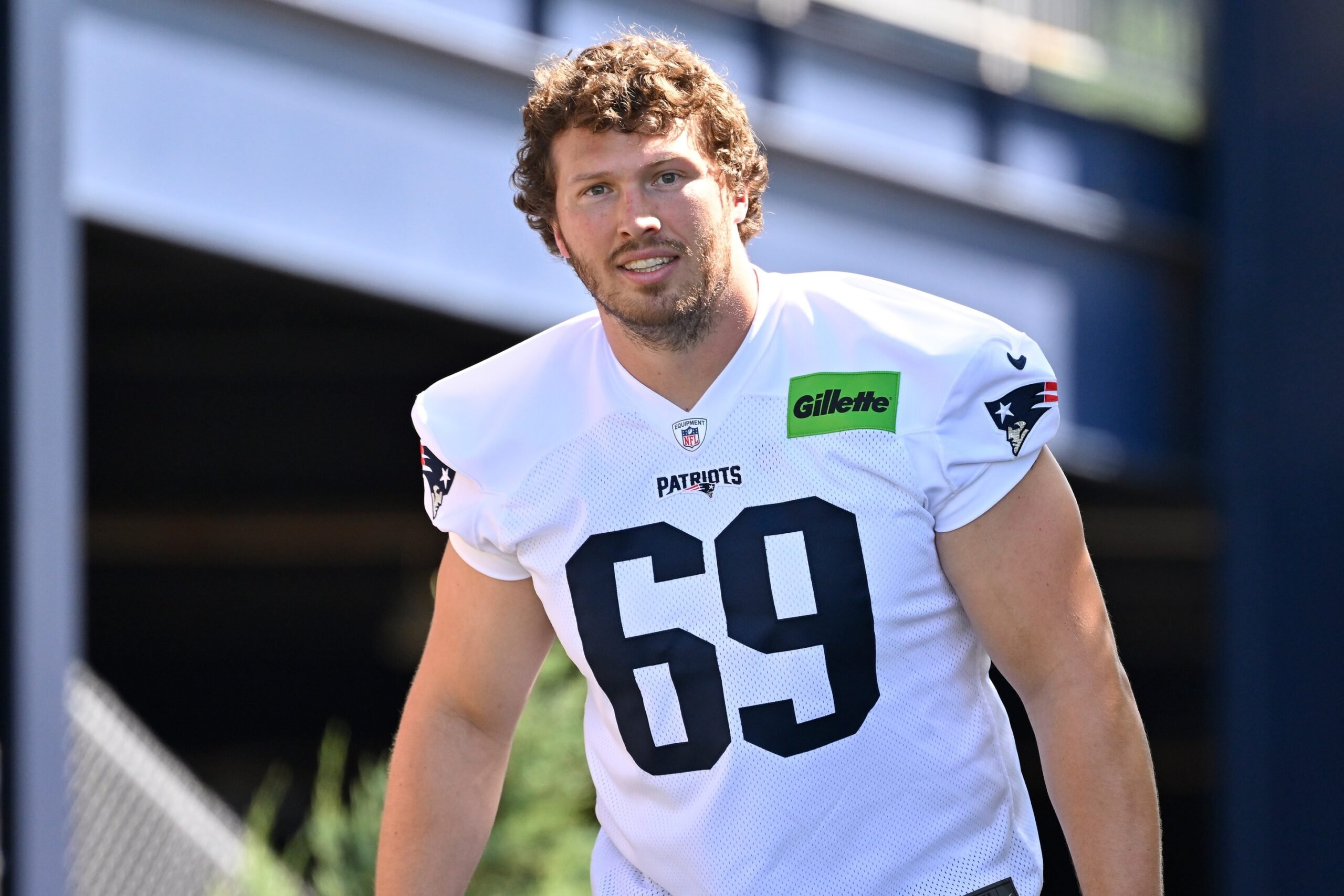 Jul 23, 2025; Foxborough, MA, USA; New England Patriots guard Cole Strange (69) walks to the practice field for training camp at Gillette Stadium. Mandatory Credit: Eric Canha-Imagn Images