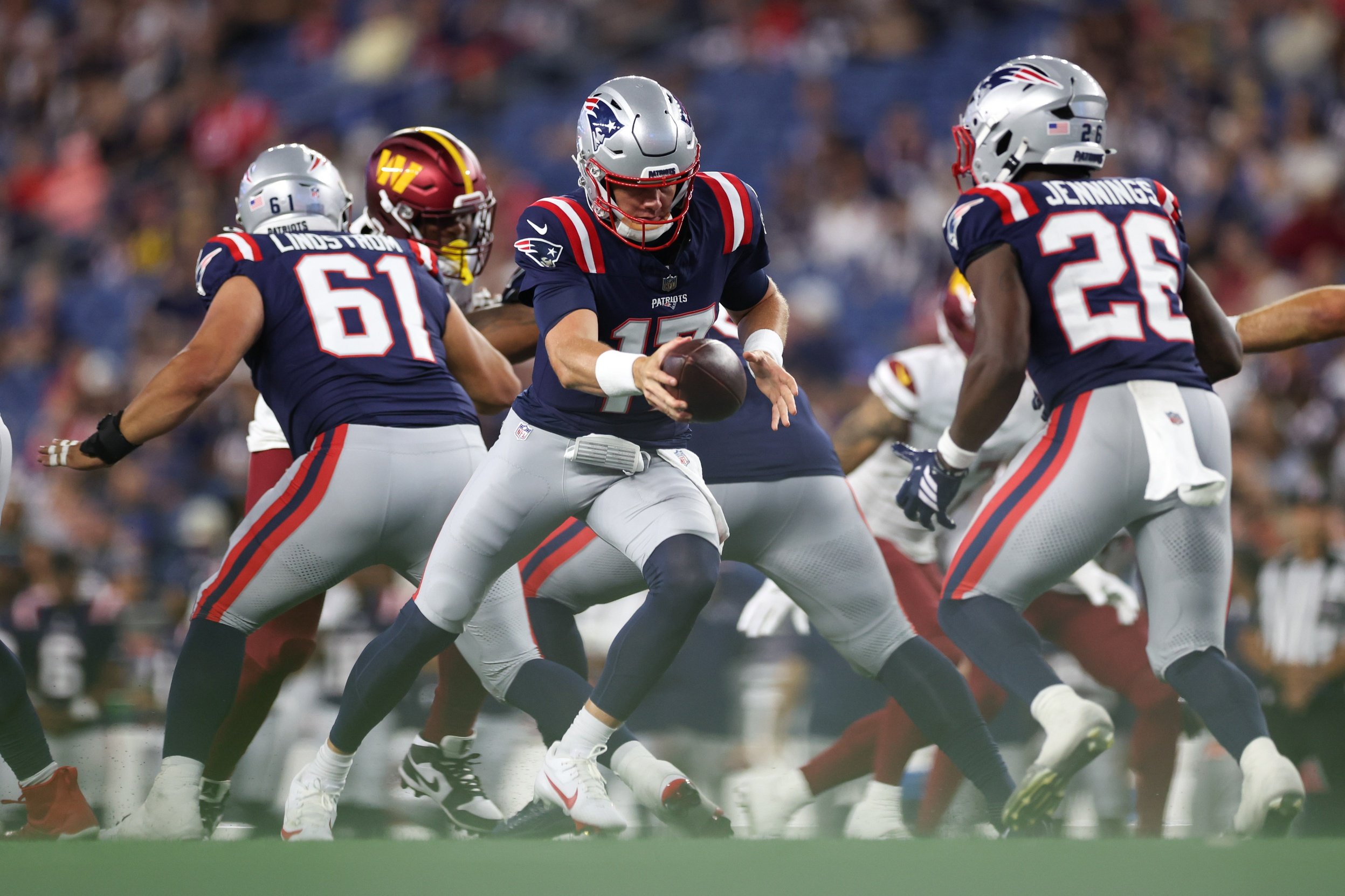 Aug 8, 2025; Foxborough, Massachusetts, USA; New England Patriots quarterback Ben Wooldridge (17) hands the ball off during the second half against the Washington Commanders at Gillette Stadium. Mandatory Credit: Paul Rutherford-Imagn Images