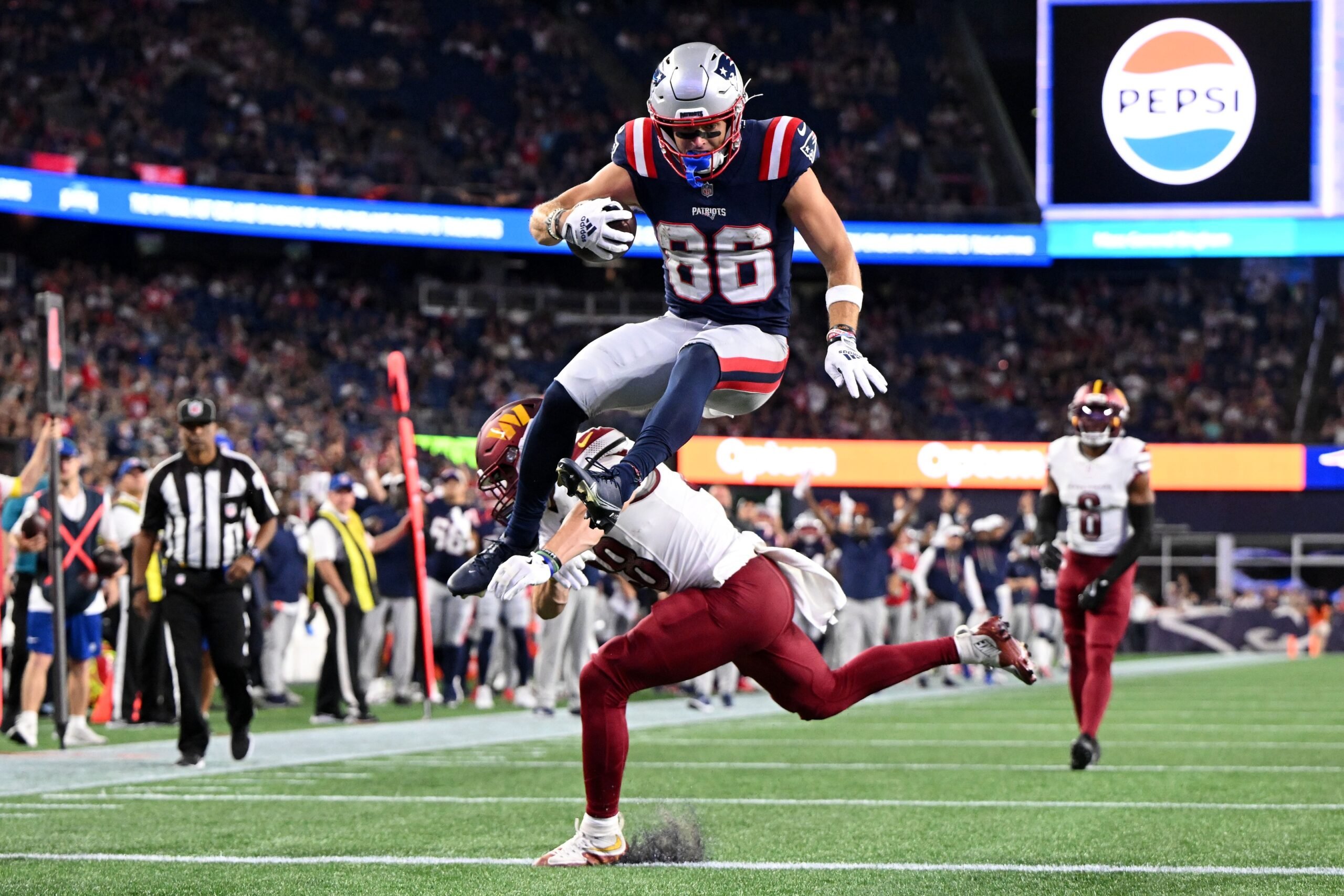 Aug 8, 2025; Foxborough, Massachusetts, USA; New England Patriots wide receiver Efton Chism III (86) scores a touchdown against the Washington Commanders during the second half at Gillette Stadium. Mandatory Credit: Brian Fluharty-Imagn Images