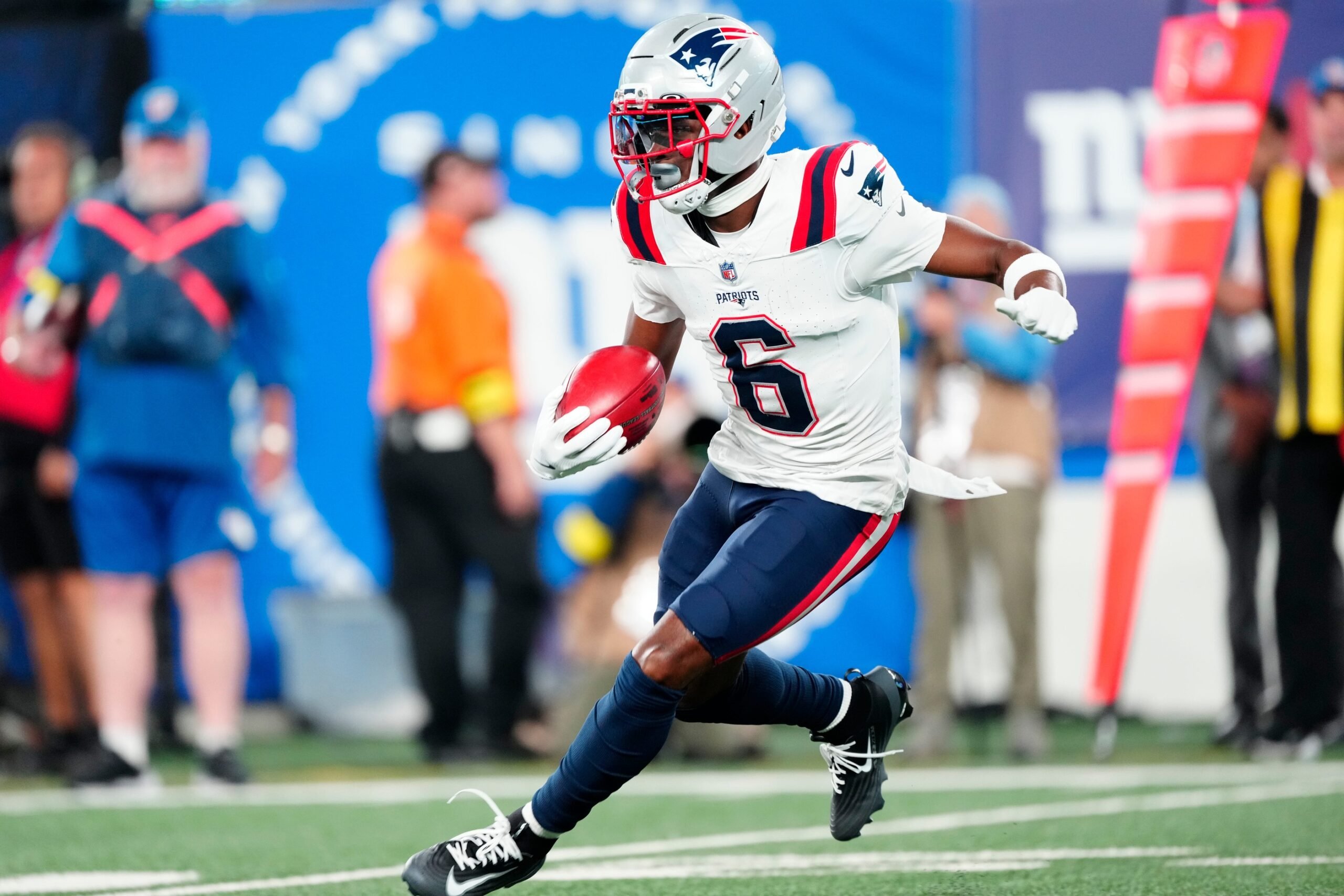 New England Patriots wide receiver Javon Baker (6) runs with the punt return in the first quarter, Thursday, August 21, 2025, in East Rutherford.