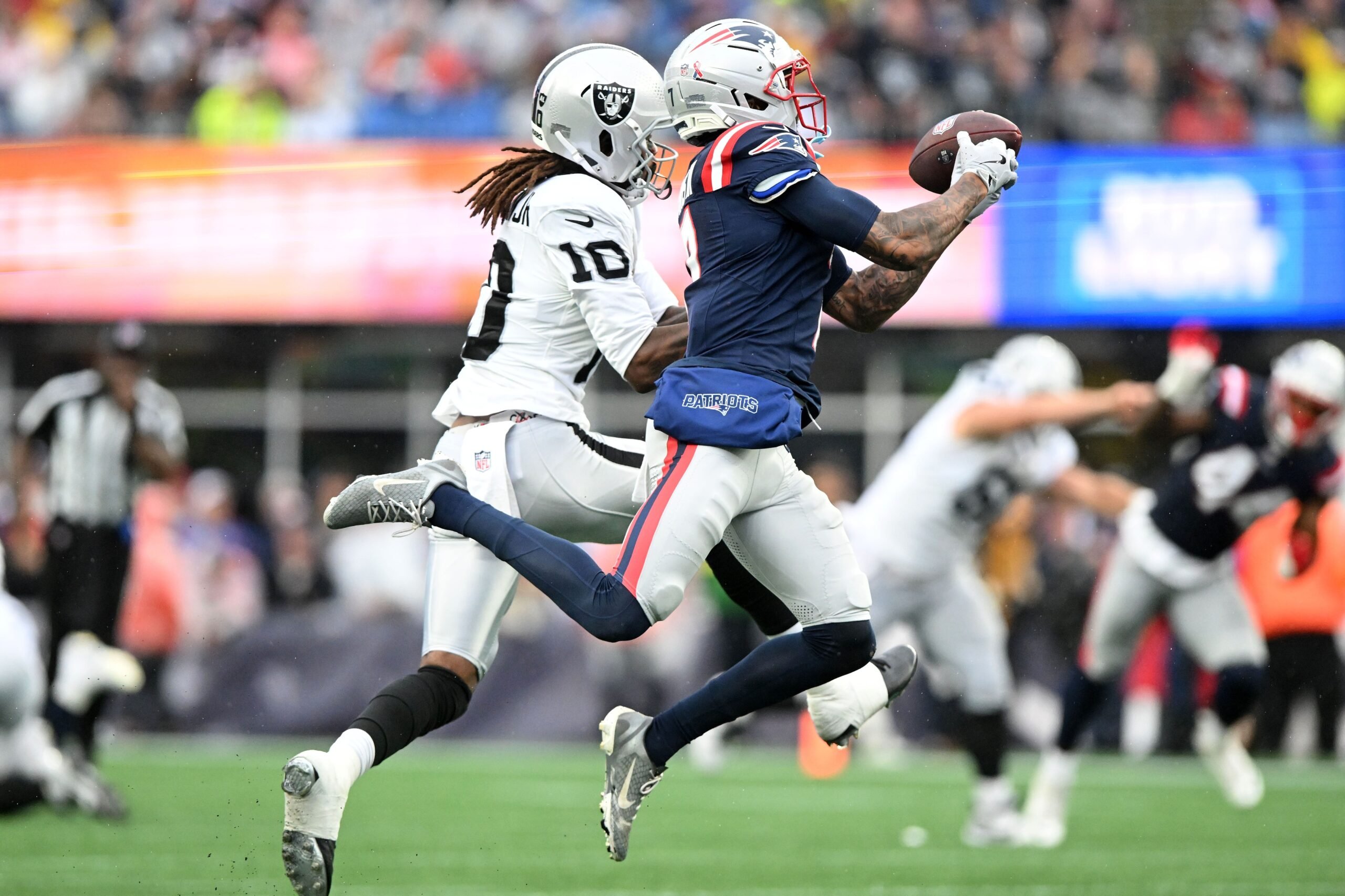 Sep 7, 2025; Foxborough, Massachusetts, USA; New England Patriots cornerback Carlton Davis III (7) breaks up a pass against Las Vegas Raiders wide receiver Dont'e Thornton Jr. (10) during the second half at Gillette Stadium. Mandatory Credit: Brian Fluharty-Imagn Images