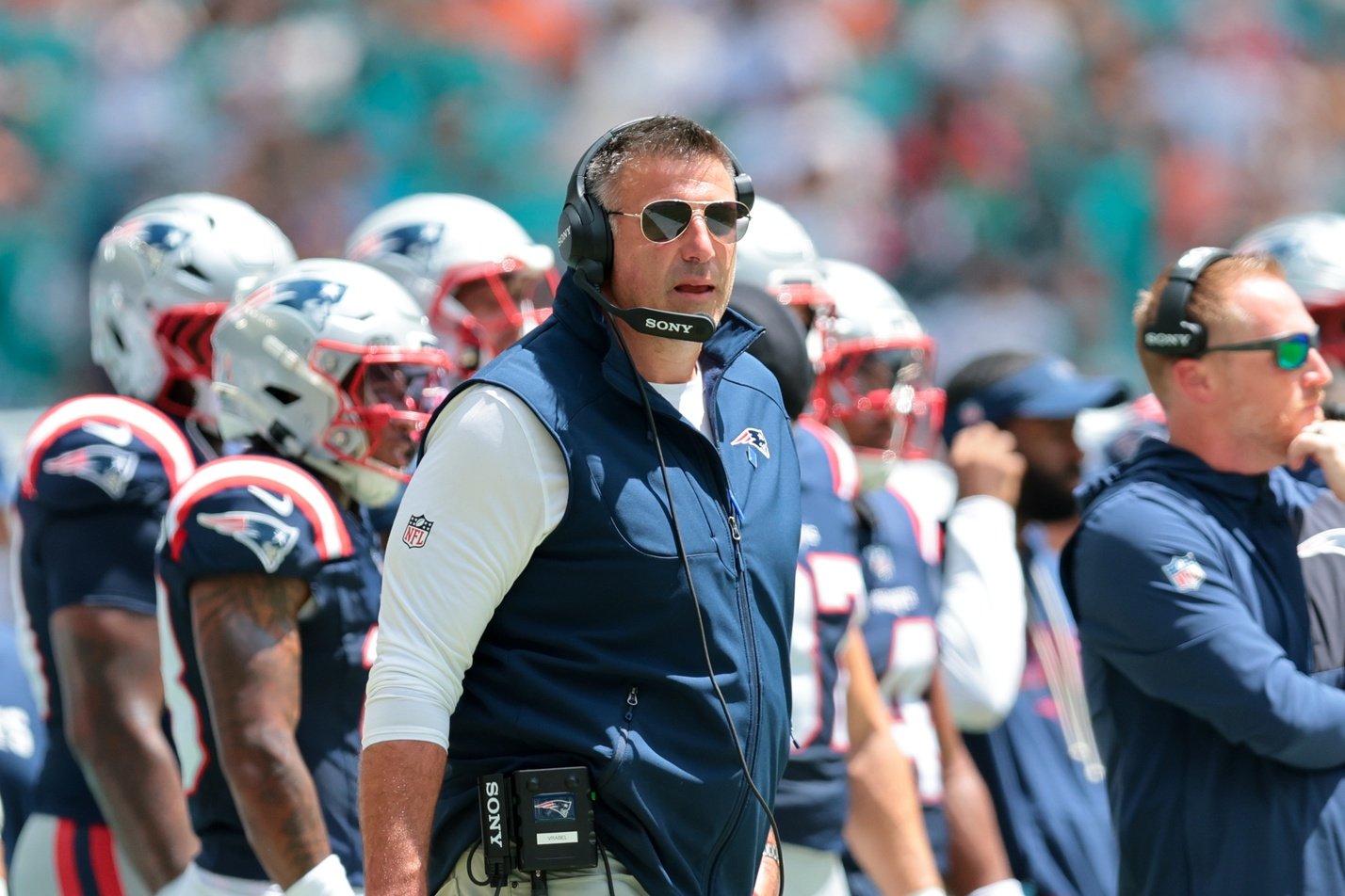 Sep 14, 2025; Miami Gardens, Florida, USA; New England Patriots head coach Mike Vrabel watches from the sideline against the Miami Dolphins during the first quarter at Hard Rock Stadium. Mandatory Credit: Sam Navarro-Imagn Images