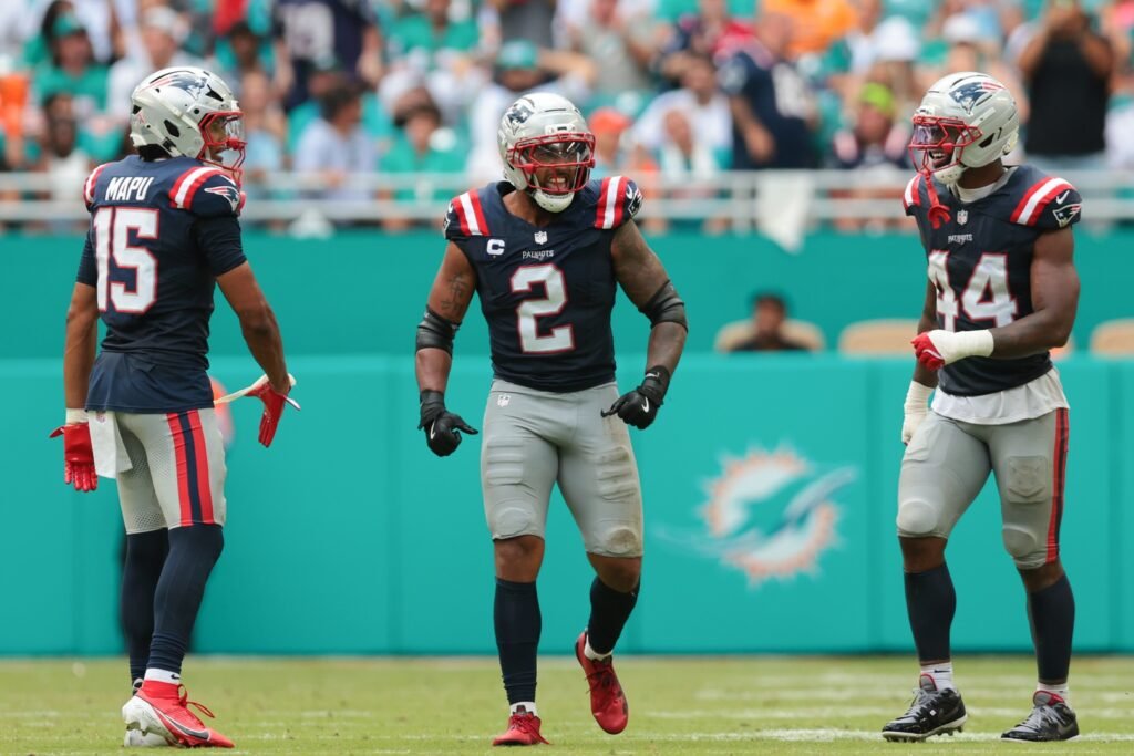 Sep 14, 2025; Miami Gardens, Florida, USA; New England Patriots linebacker Harold Landry III (2) celebrates with linebacker Marte Mapu (15) and linebacker K'Lavon Chaisson (44) after sacking Miami Dolphins quarterback Tua Tagovailoa (not pictured) during the fourth quarter at Hard Rock Stadium. Mandatory Credit: Sam Navarro-Imagn Images