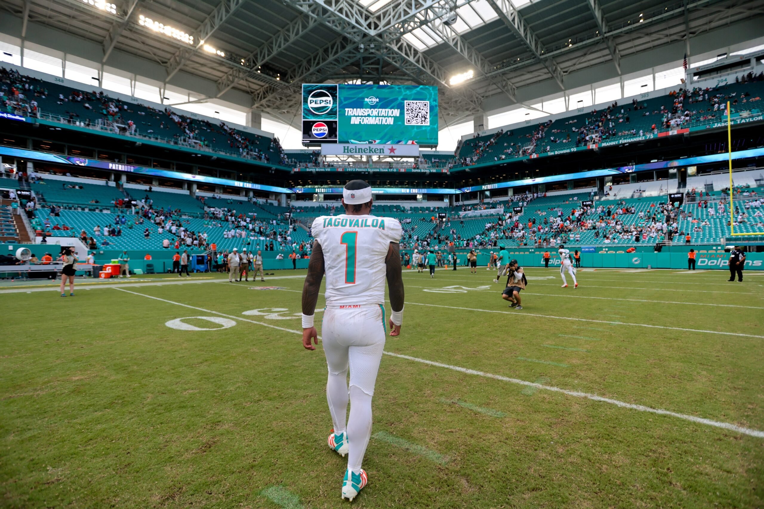 Sep 14, 2025; Miami Gardens, Florida, USA; Miami Dolphins quarterback Tua Tagovailoa (1) walks off the field after the game against the New England Patriots at Hard Rock Stadium. Mandatory Credit: Sam Navarro-Imagn Images