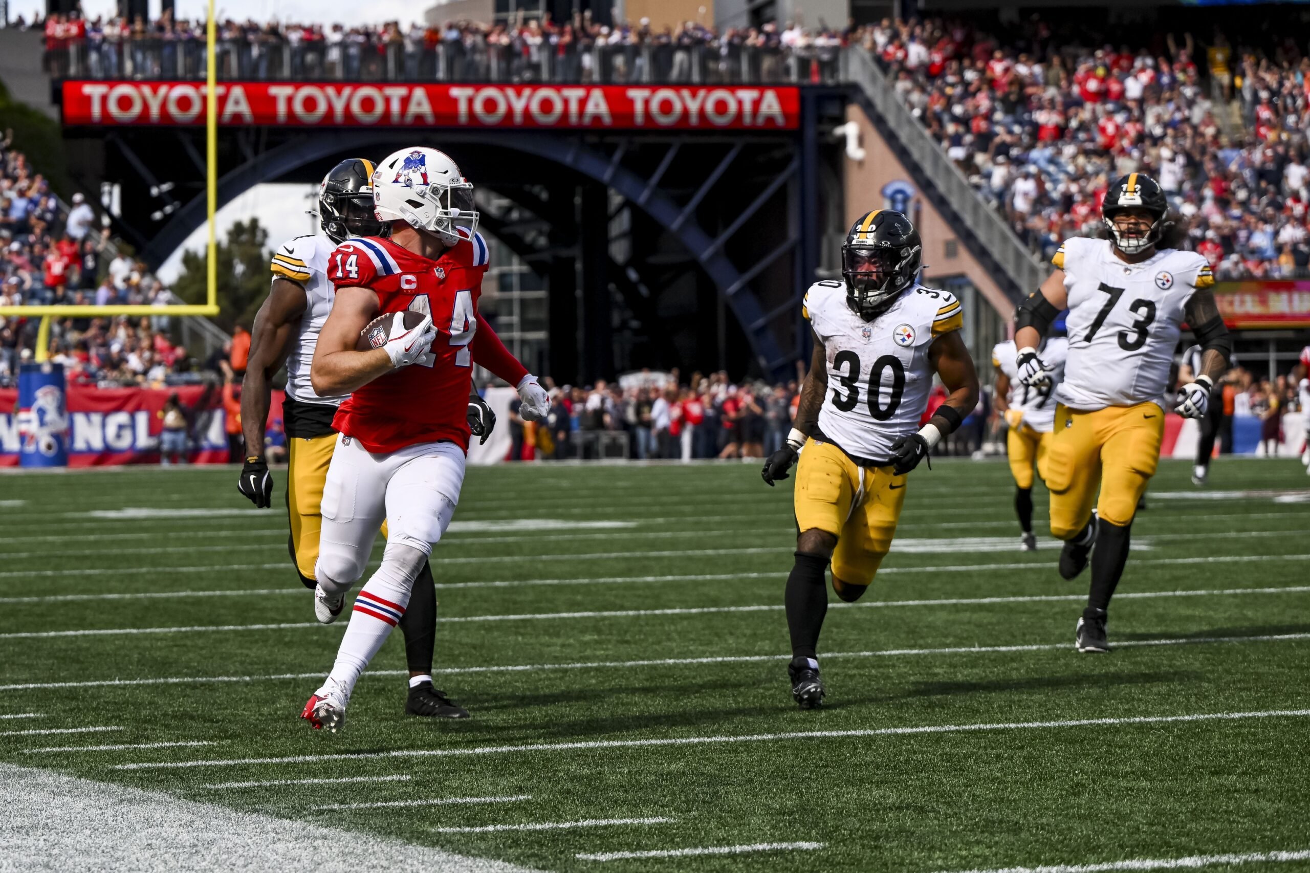 Sep 21, 2025; Foxborough, Massachusetts, USA; New England Patriots linebacker Robert Spillane (14) returns an interception during the third quarter at Gillette Stadium. Mandatory Credit: Brian Fluharty-Imagn Images
