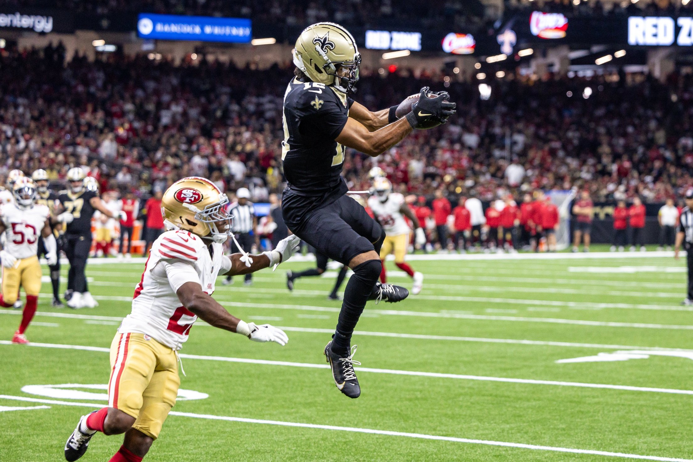 Sep 14, 2025; New Orleans, Louisiana, USA;  New Orleans Saints wide receiver Chris Olave (12) catches a pass against San Francisco 49ers cornerback Upton Stout (20) during the second half at Caesars Superdome. Mandatory Credit: Stephen Lew-Imagn Images