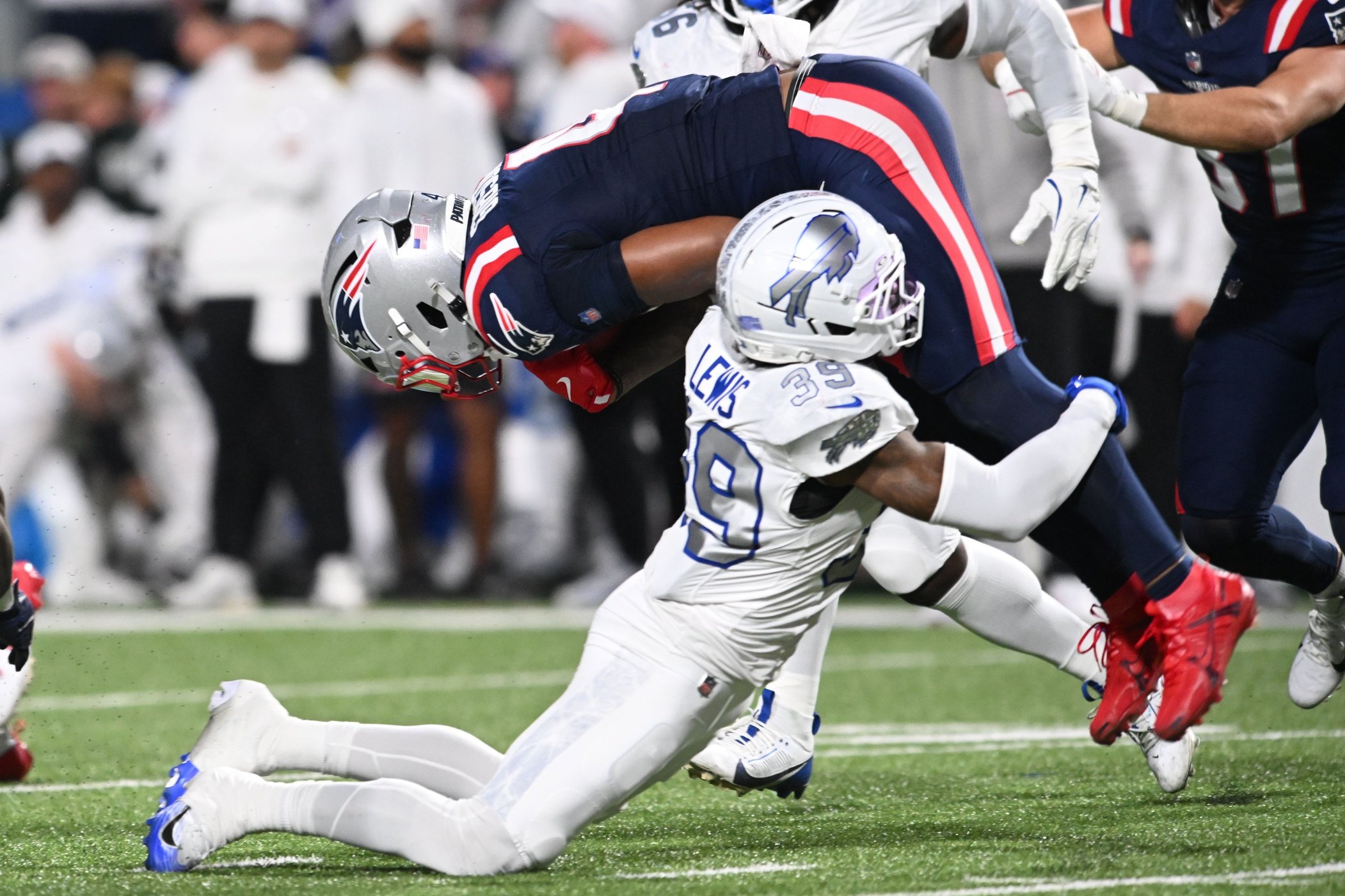 Oct 5, 2025; Orchard Park, New York, USA; Buffalo Bills cornerback Cam Lewis (39) tackles New England Patriots running back Antonio Gibson (4) to fumble during the first half at Highmark Stadium. Mandatory Credit: Mark Konezny-Imagn Images
