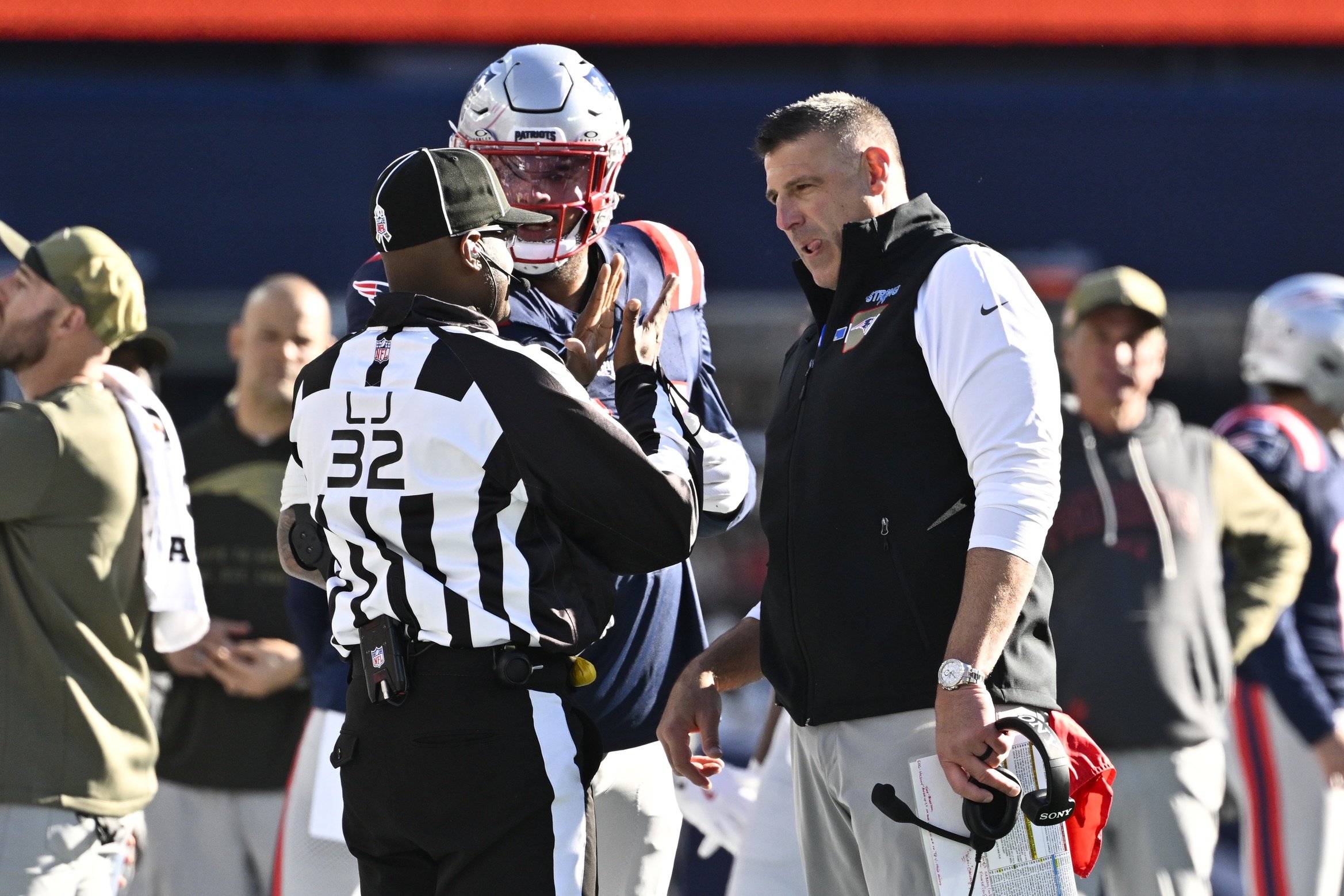 Nov 2, 2025; Foxborough, Massachusetts, USA;  New England Patriots head coach Mike Vrabel and defensive tackle Cory Durden (94) talk with  line judge Walter Flowers (32) during the first half of the game against the Atlanta Falcons at Gillette Stadium. Mandatory Credit: Eric Canha-Imagn Images