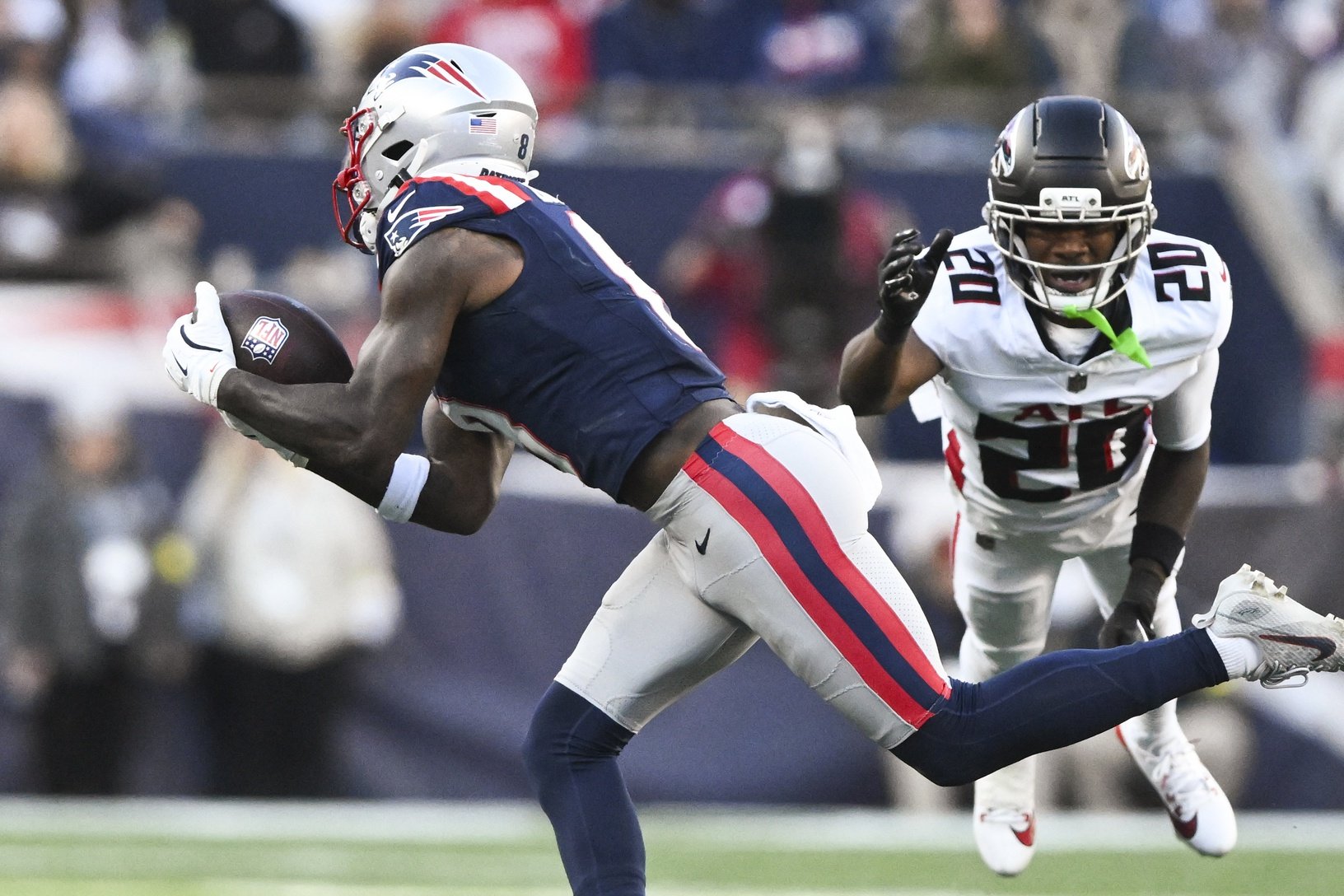 Nov 2, 2025; Foxborough, Massachusetts, USA; New England Patriots wide receiver Stefon Diggs (8) makes a catch against Atlanta Falcons cornerback Dee Alford (20) and safety Jessie Bates III (3) during the second half at Gillette Stadium. Mandatory Credit: Brian Fluharty-Imagn Images