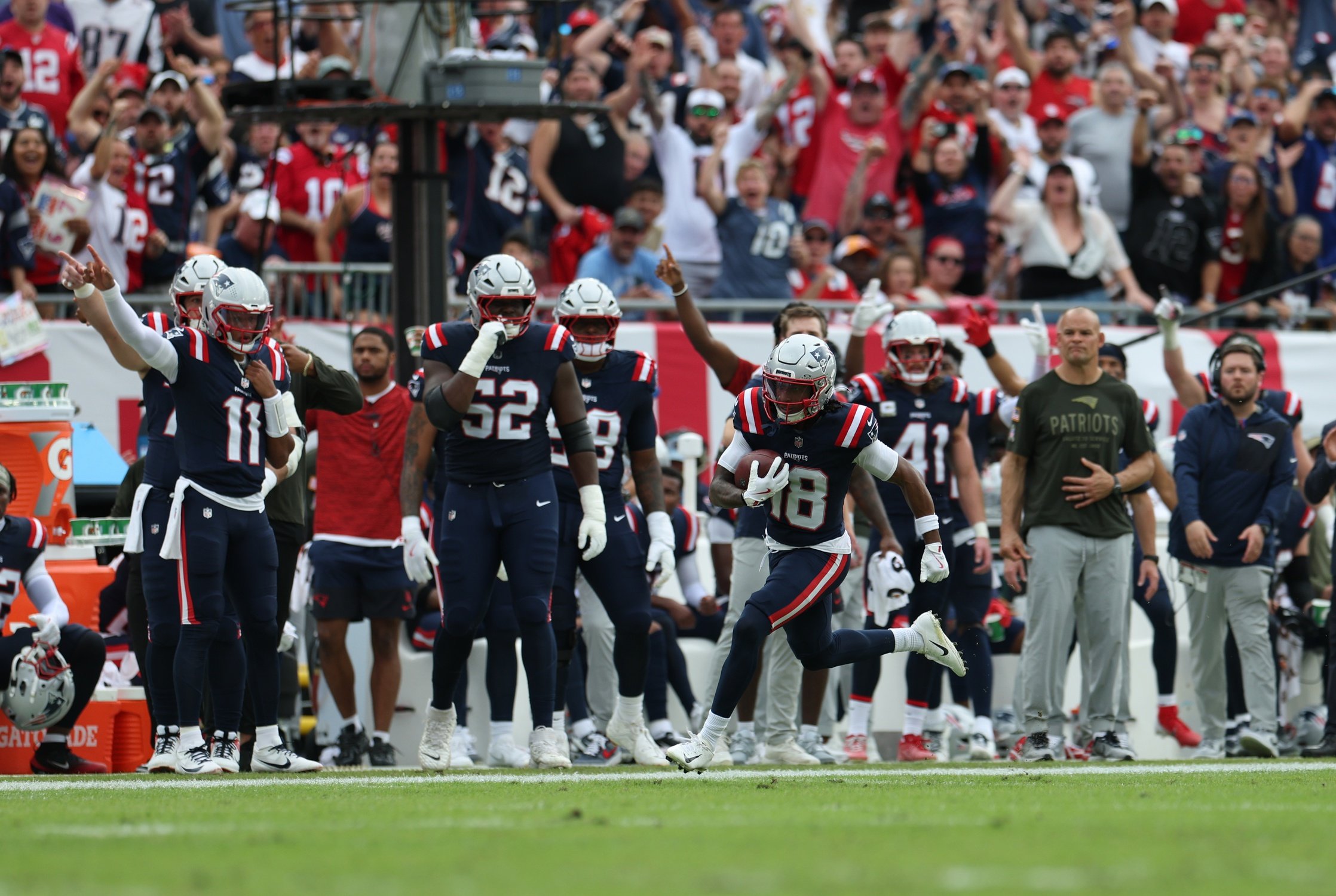 Nov 9, 2025; Tampa, Florida, USA; New England Patriots wide receiver Kyle Williams (18) runs for a touchdown during the second quarter against the Tampa Bay Buccaneers at Raymond James Stadium. Mandatory Credit: Nathan Ray Seebeck-Imagn Images