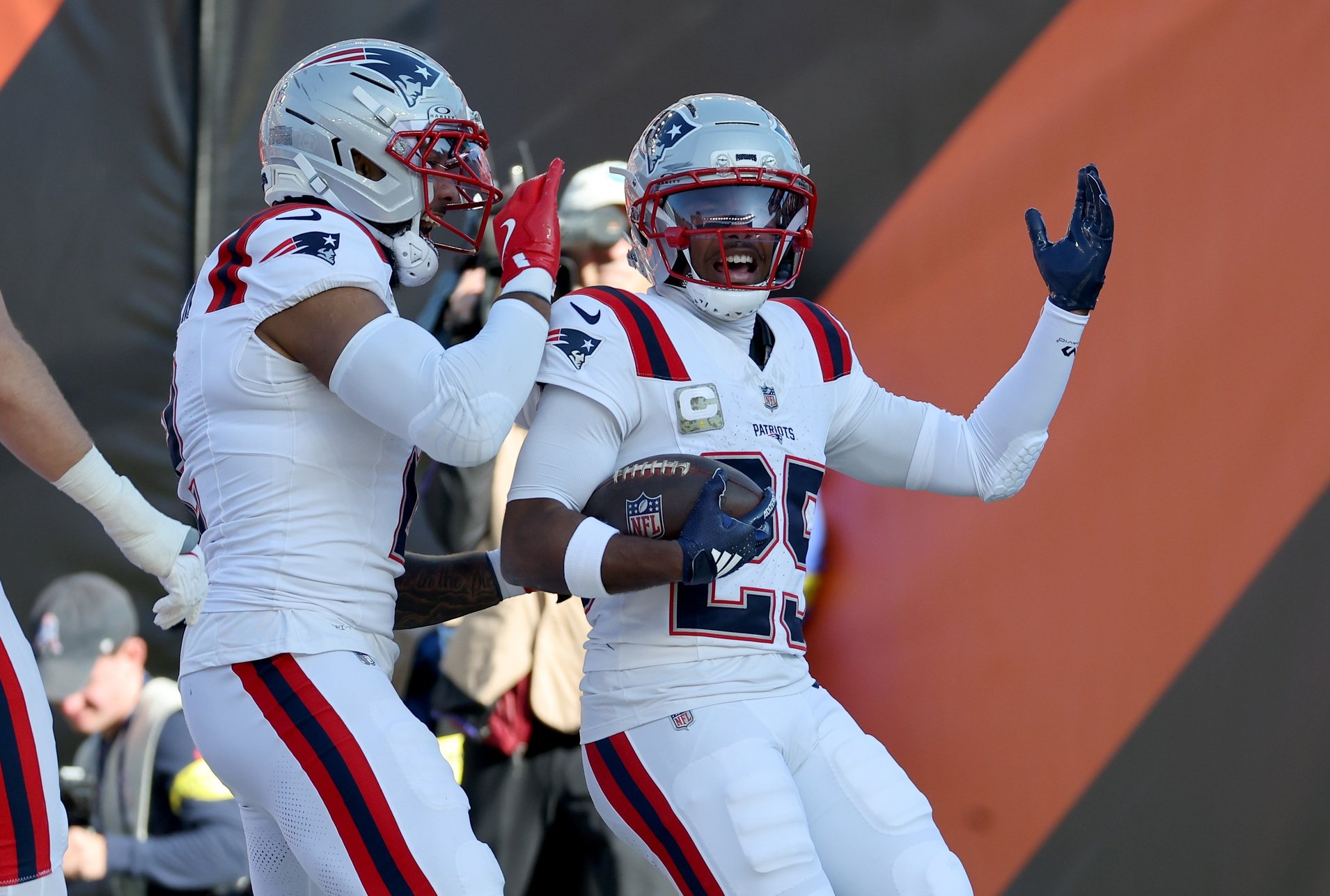 Nov 23, 2025; Cincinnati, Ohio, USA; New England Patriots cornerback Marcus Jones (25) celebrates with teammates after scoring a touchdown during the first half against the Cincinnati Bengals at Paycor Stadium. Mandatory Credit: Joseph Maiorana-Imagn Images