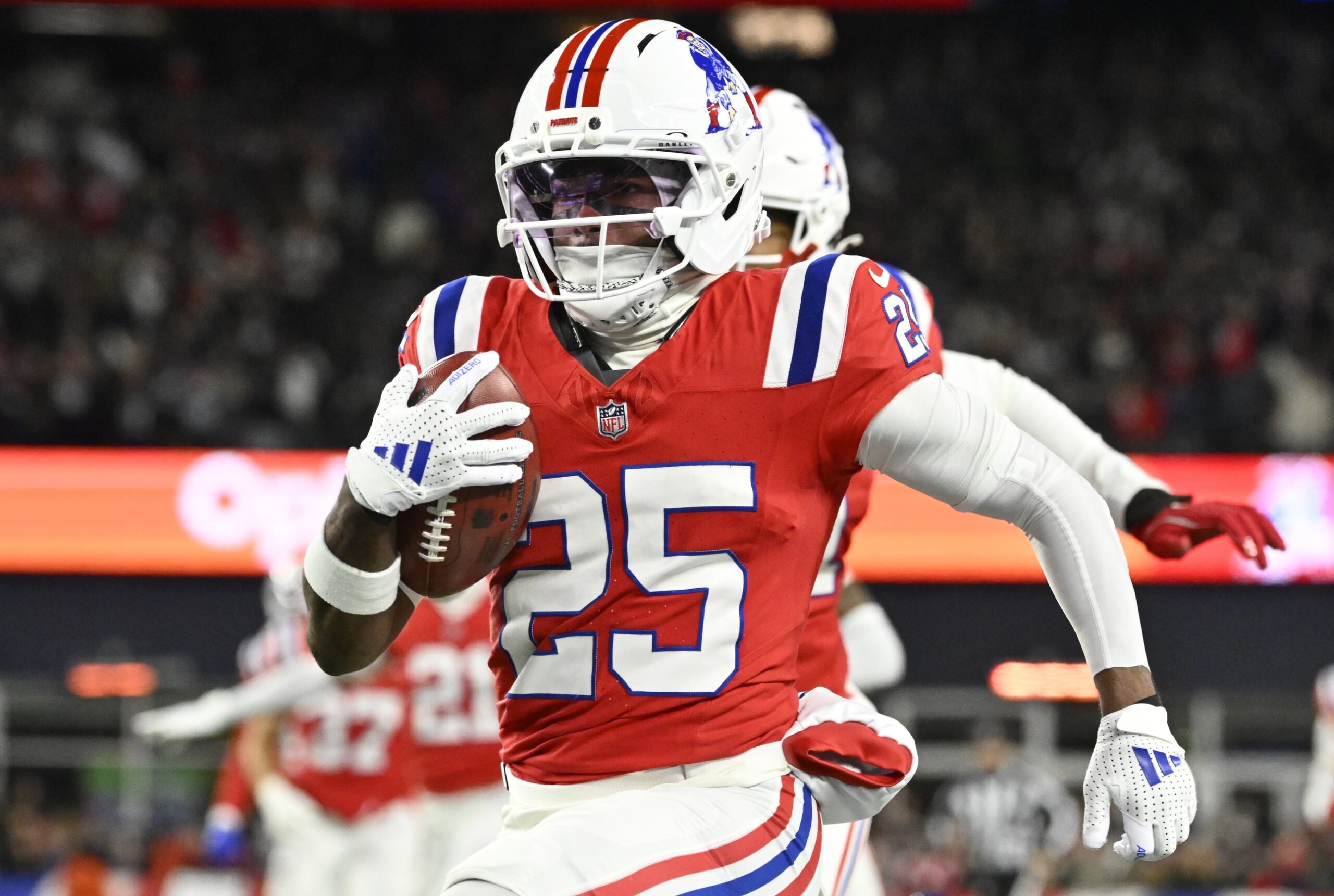 Dec 1, 2025; Foxborough, Massachusetts, USA; New England Patriots cornerback Marcus Jones (25) returns a punt for a touchdown during the first quarter against the New York Giants at Gillette Stadium. Mandatory Credit: Eric Canha-Imagn Images