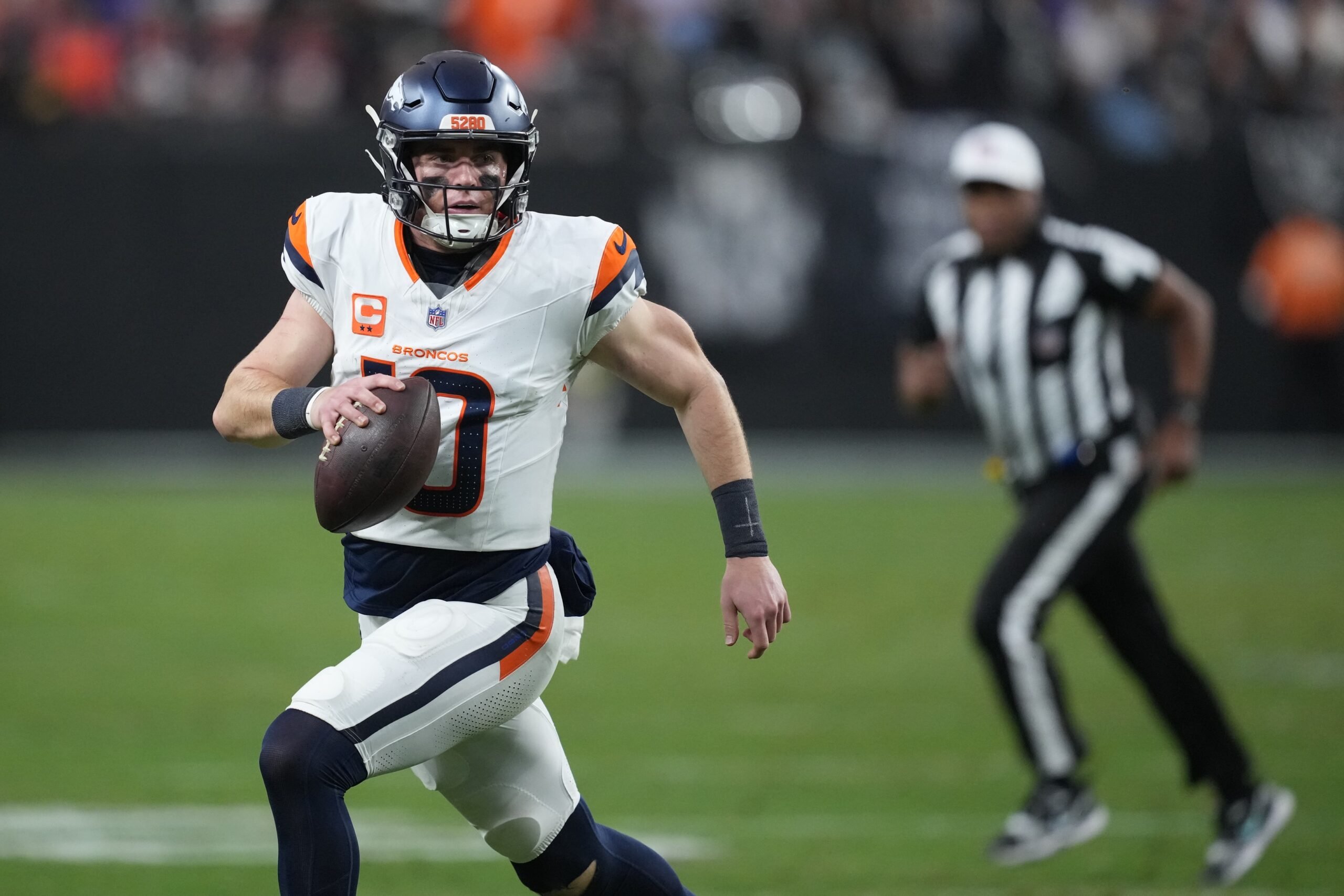 Dec 7, 2025; Paradise, Nevada, USA; Denver Broncos quarterback Bo Nix (10) scrambles against the Las Vegas Raiders during the second half at Allegiant Stadium. Mandatory Credit: Kirby Lee-Imagn Images