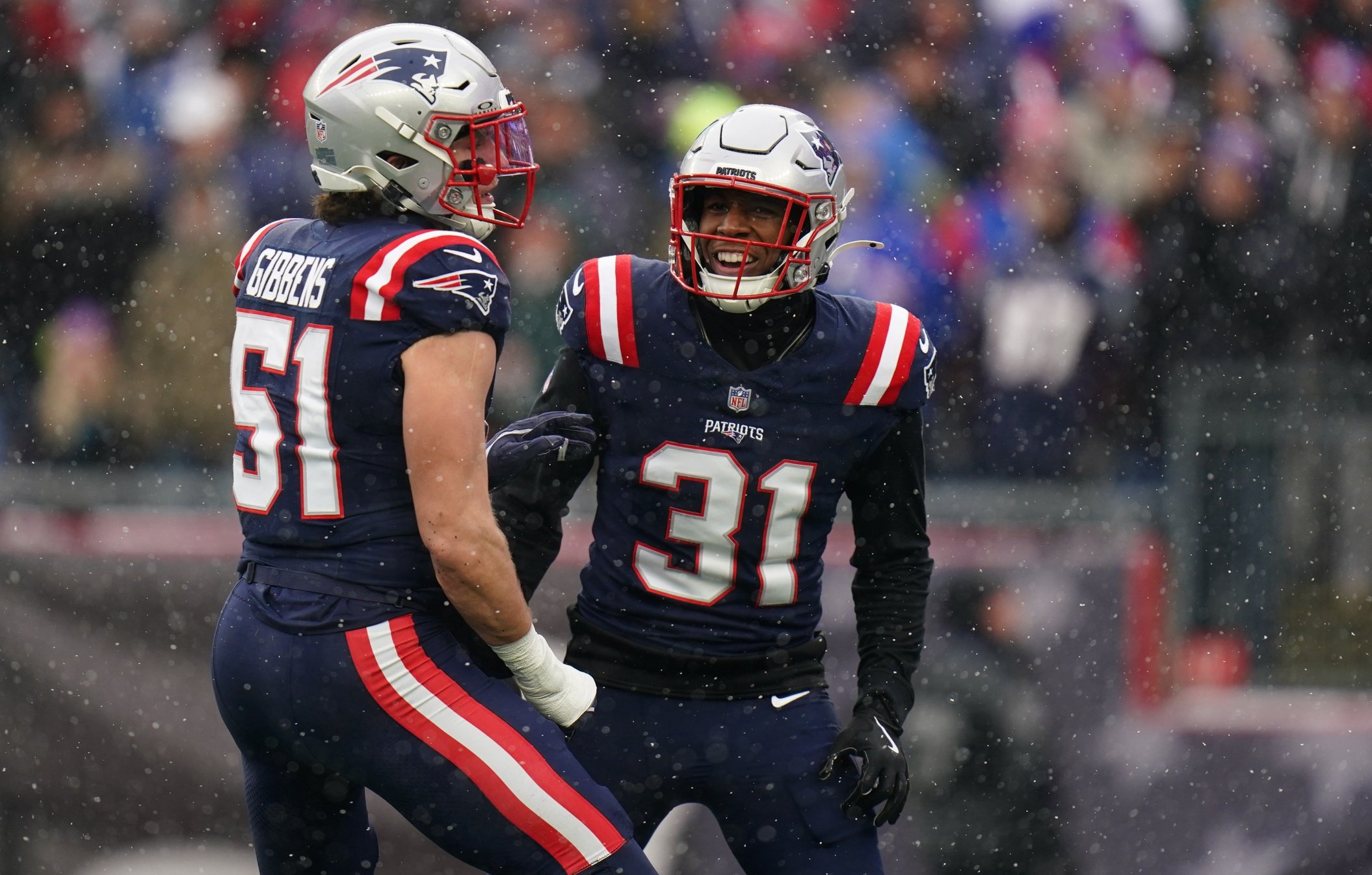 Dec 14, 2025; Foxborough, Massachusetts, USA; New England Patriots linebacker Jack Gibbens (51) and safety Craig Woodson (31) react after a play against the Buffalo Bills in the first half at Gillette Stadium. Mandatory Credit: David Butler II-Imagn Images