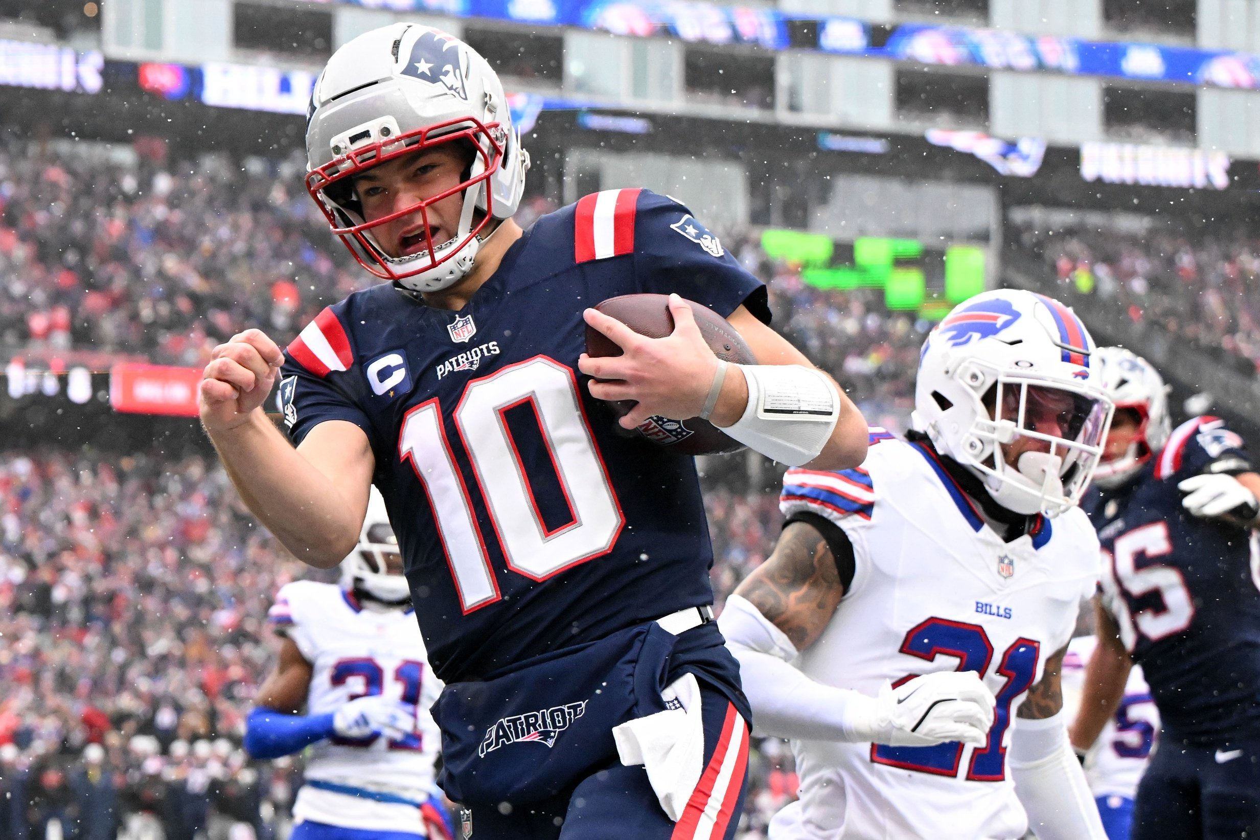 Dec 14, 2025; Foxborough, Massachusetts, USA; New England Patriots quarterback Drake Maye (10) runs for a touchdown against the Buffalo Bills during the first half at Gillette Stadium. Mandatory Credit: Brian Fluharty-Imagn Images