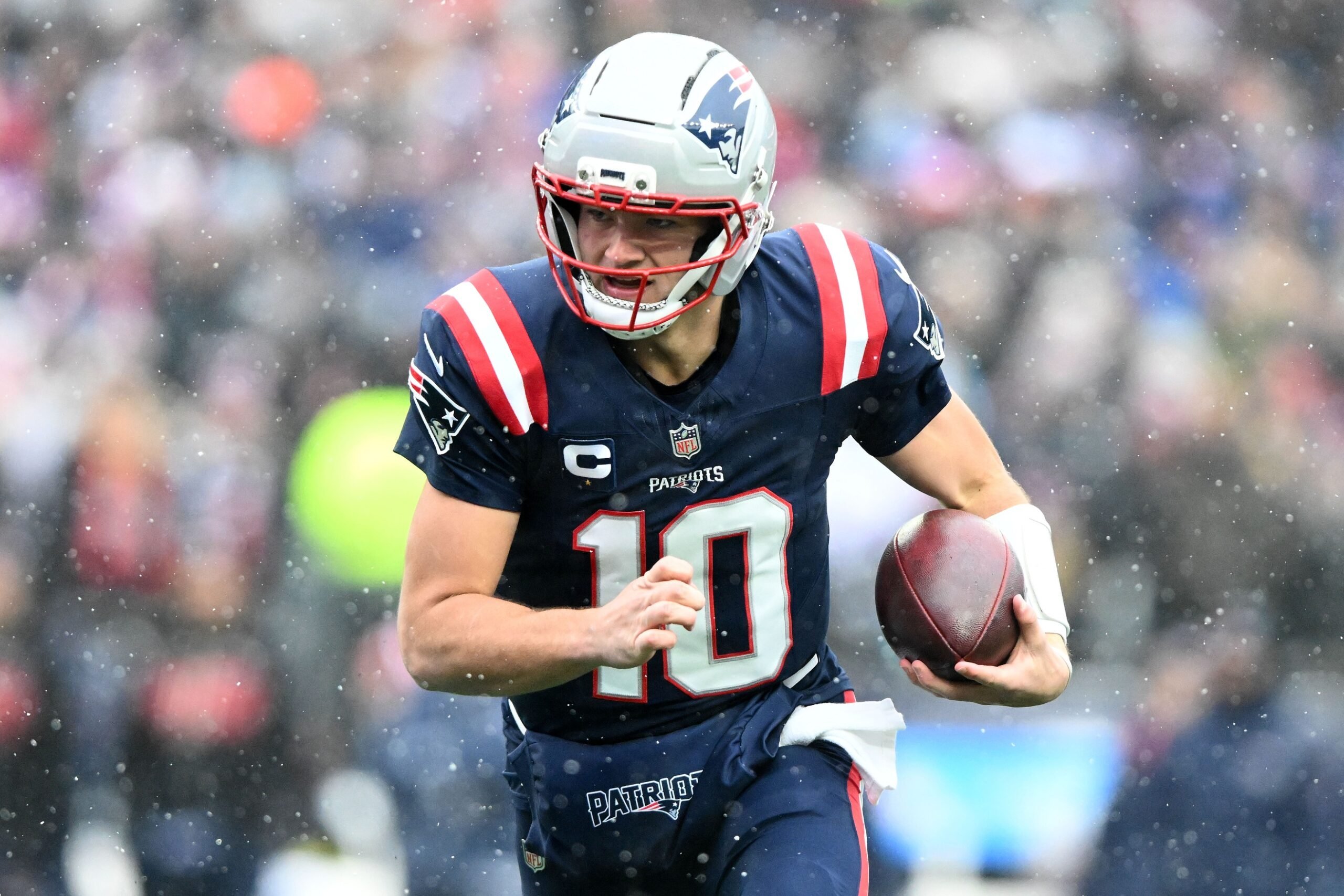 Dec 14, 2025; Foxborough, Massachusetts, USA; New England Patriots quarterback Drake Maye (10) runs against the Buffalo Bills during the first half at Gillette Stadium. Mandatory Credit: Brian Fluharty-Imagn Images