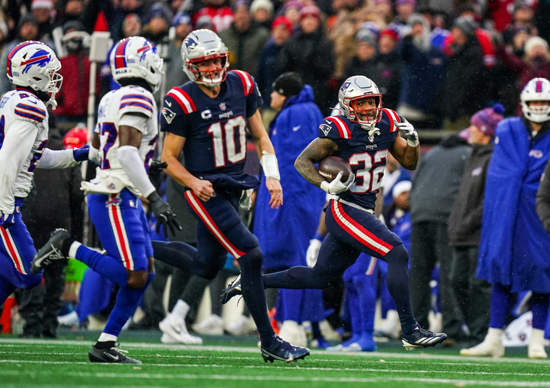 Dec 14, 2025; Foxborough, Massachusetts, USA; New England Patriots running back Treveyon Henderson (32) runs the ball with help from quarterback Drake Maye (10) for a touchdown against the Buffalo Bills in the second half at Gillette Stadium. Mandatory Credit: David Butler II-Imagn Images