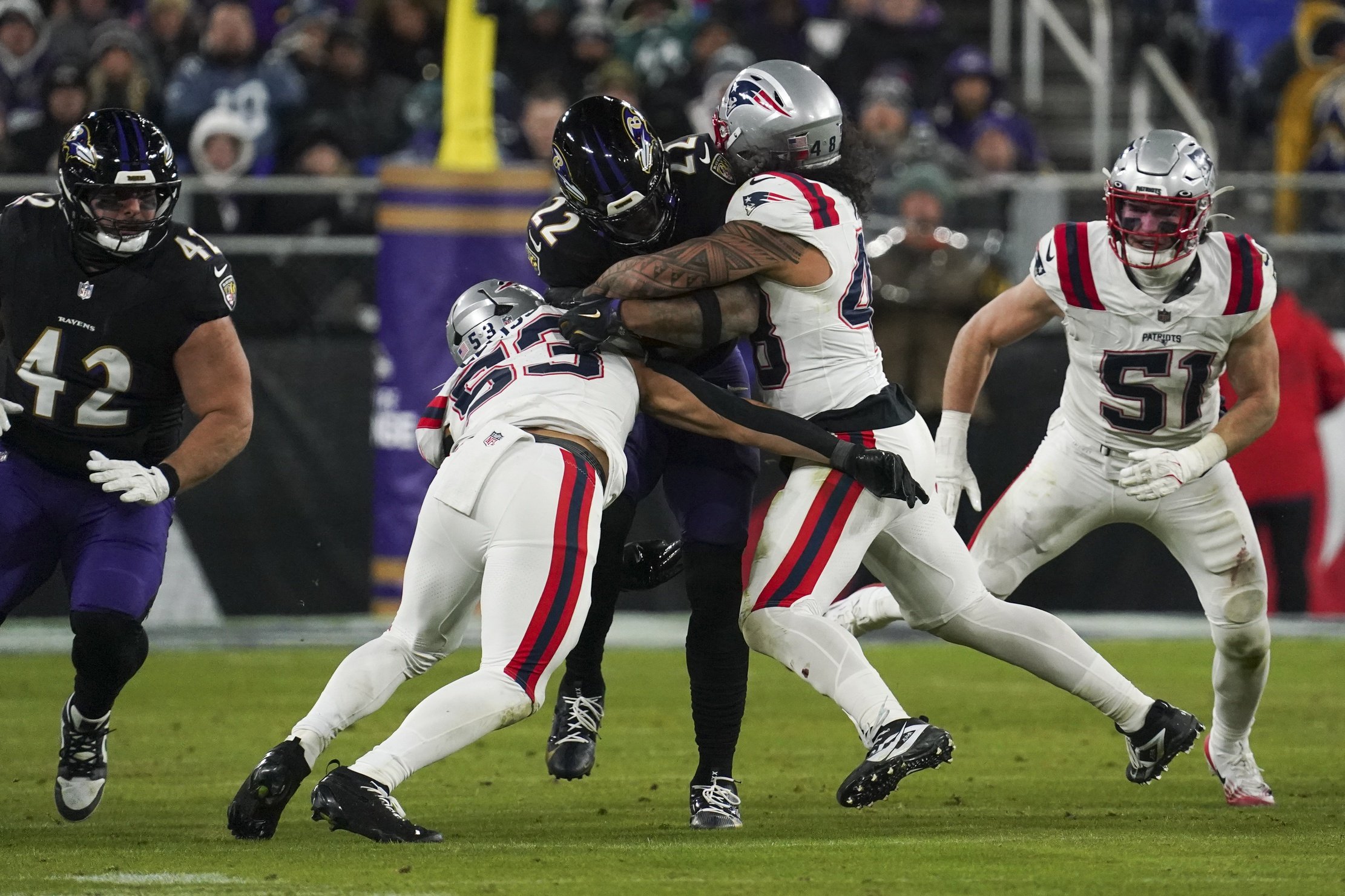 Dec 21, 2025; Baltimore, Maryland, USA;  Baltimore Ravens running back Derrick Henry (22) runs the ball against New England Patriots linebacker Christian Elliss (53) during the second half of the game at M&T Bank Stadium. Mandatory Credit: James Lang-Imagn Images