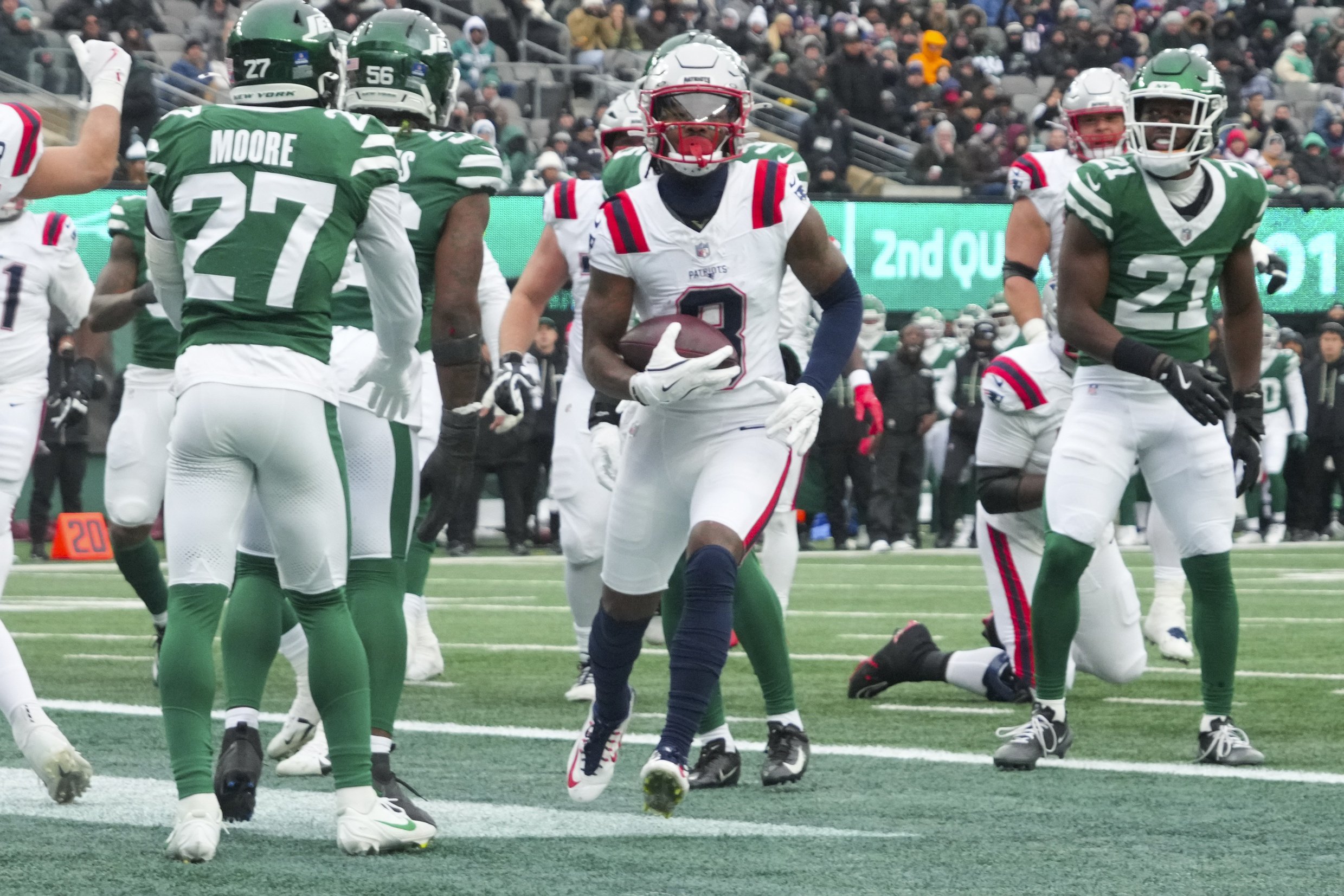 Dec 28, 2025; East Rutherford, New Jersey, USA; New England Patriots wide receiver Stefon Diggs (8) scores a touchdown against the New York Jets during the second quarter of the game at MetLife Stadium. Mandatory Credit: Robert Deutsch-Imagn Images
