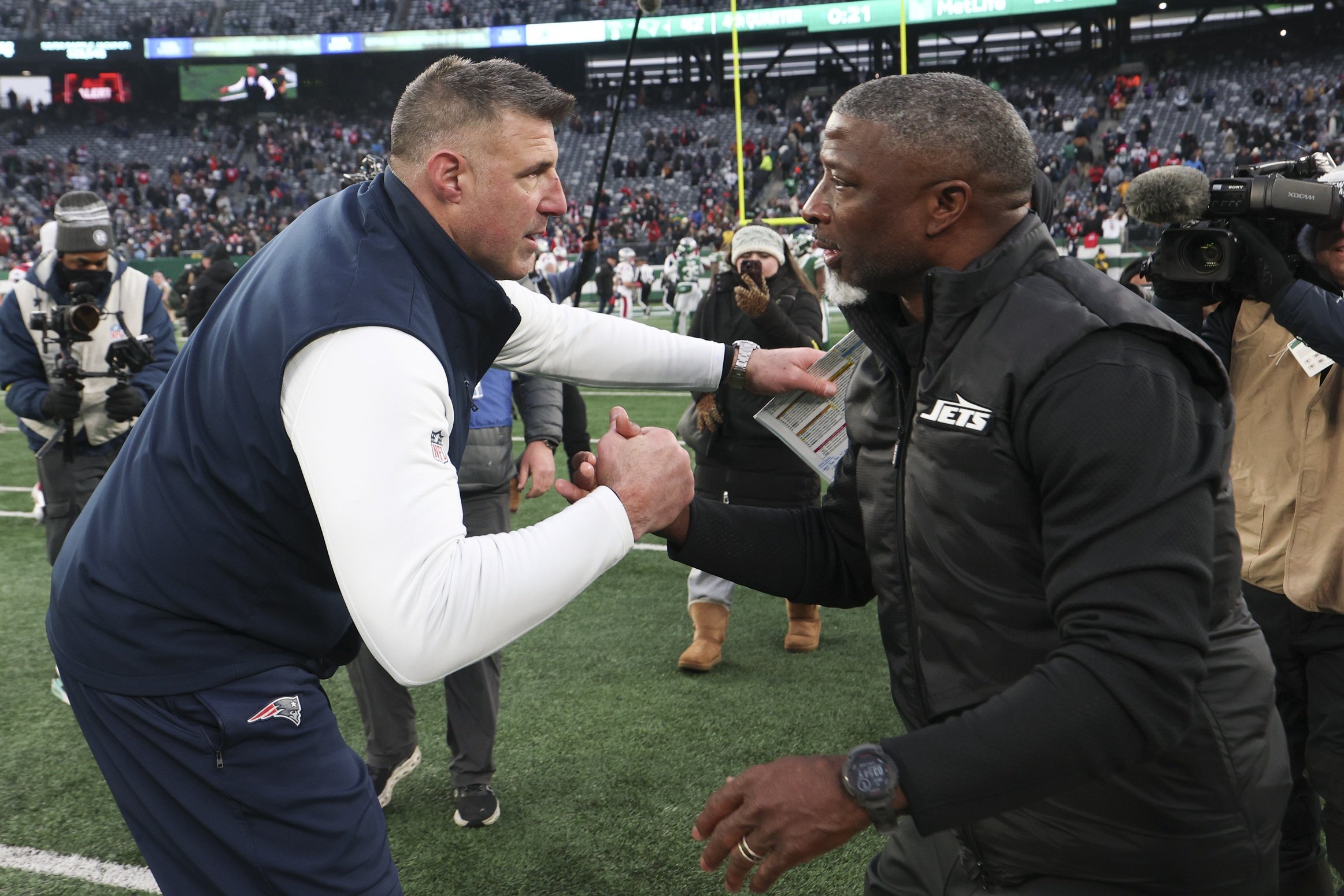 Dec 28, 2025; East Rutherford, New Jersey, USA; New England Patriots head coach Mike Vrabel and New York Jets head coach Aaron Glenn shake hands after the game at MetLife Stadium. Mandatory Credit: Vincent Carchietta-Imagn Images