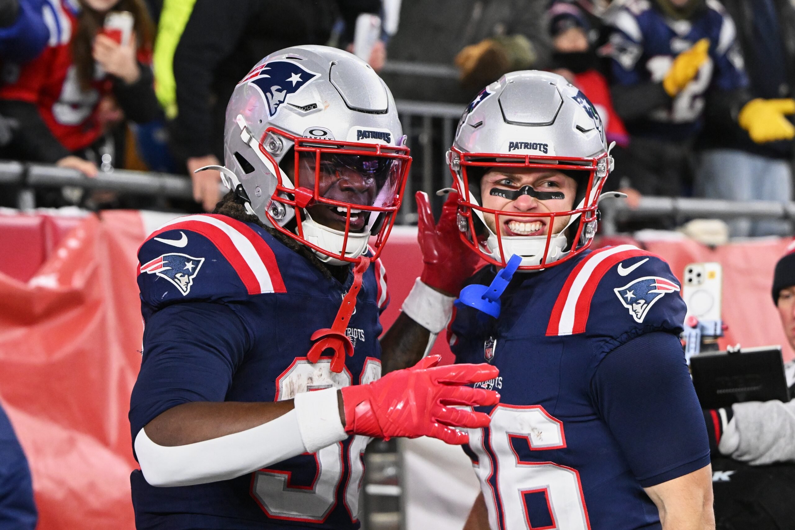 Jan 4, 2026; Foxborough, Massachusetts, USA; New England Patriots running back Rhamondre Stevenson (38) celebrates with wide receiver Efton Chism III (86) after scoring a touchdown against the Miami Dolphins during the fourth quarter at Gillette Stadium. Mandatory Credit: Brian Fluharty-Imagn Images