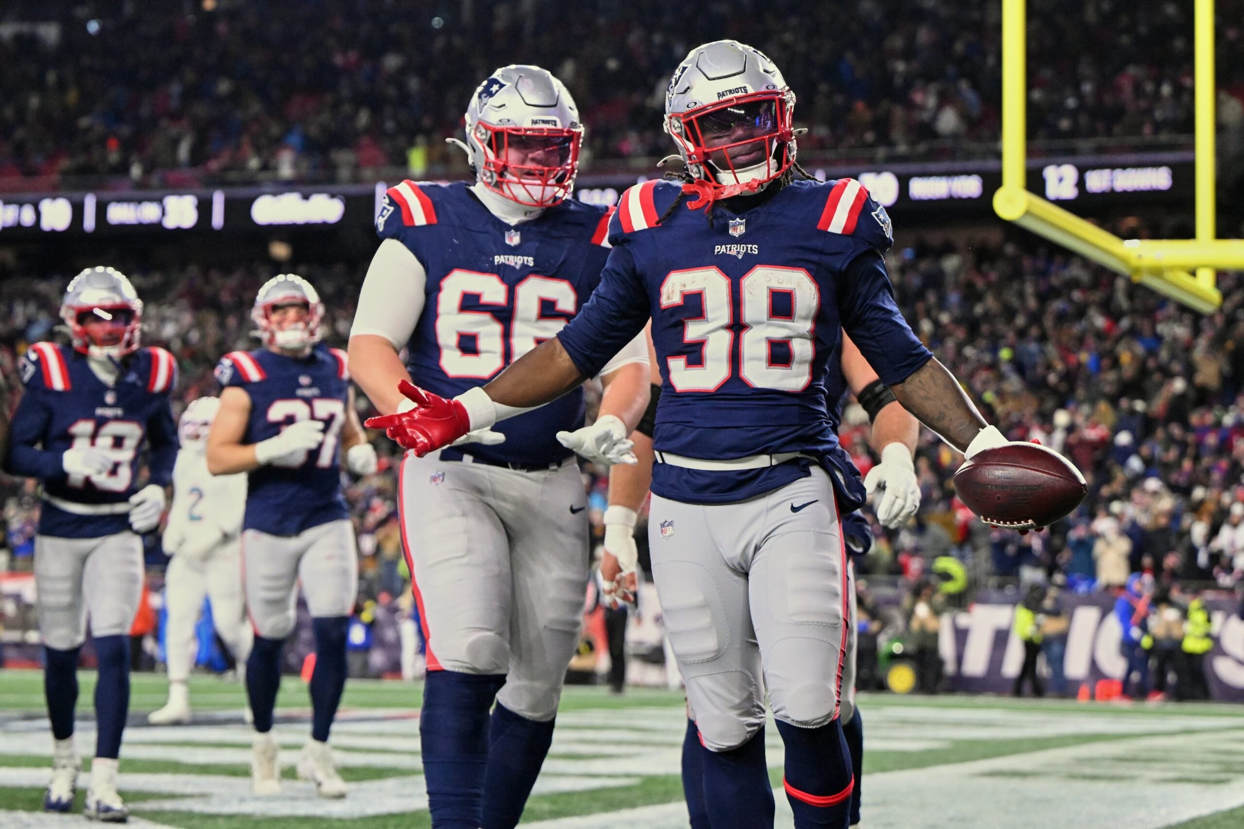 Jan 4, 2026; Foxborough, Massachusetts, USA; New England Patriots running back Rhamondre Stevenson (38) acknowledges the crowd after running for a thirty-five yard touchdown against the Miami Dolphins during the fourth quarter at Gillette Stadium. Mandatory Credit: Brian Fluharty-Imagn Images
