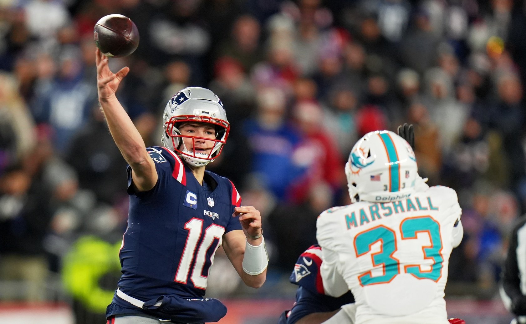 Jan 4, 2026; Foxborough, Massachusetts, USA; New England Patriots quarterback Drake Maye (10) throws a pass against Miami Dolphins cornerback Jason Marshall Jr. (33) during the second half at Gillette Stadium. Mandatory Credit: David Butler II-Imagn Images