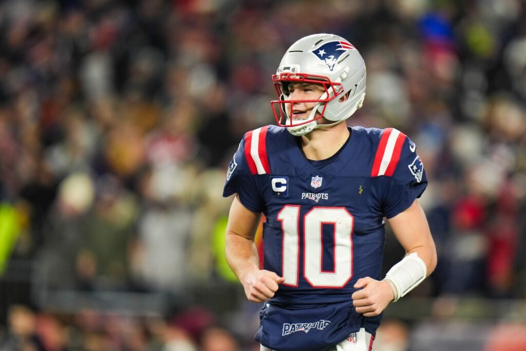 Jan 11, 2026; Foxborough, MA, USA; New England Patriots quarterback Drake Maye (10) smiles after a touchdown pass during the fourth quarter against the Los Angeles Chargers in an AFC Wild Card Round game at Gillette Stadium. Mandatory Credit: David Butler II-Imagn Images