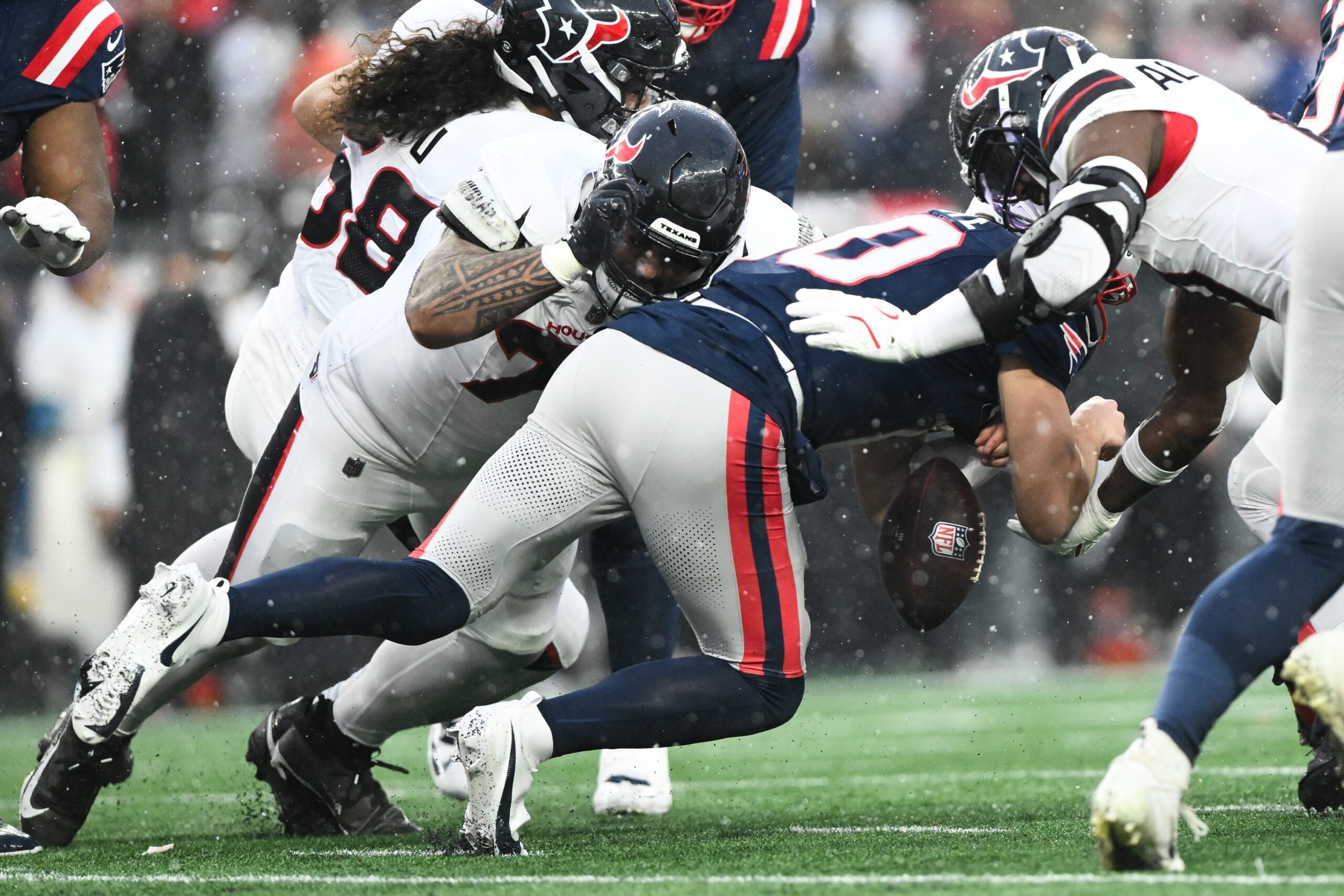 Jan 18, 2026; Foxborough, MA, USA; Houston Texans defensive tackle Tommy Togiai (72) forces a fumble from New England Patriots quarterback Drake Maye (10) in the first quarter in an AFC Divisional Round game at Gillette Stadium. Mandatory Credit: Brian Fluharty-Imagn Images