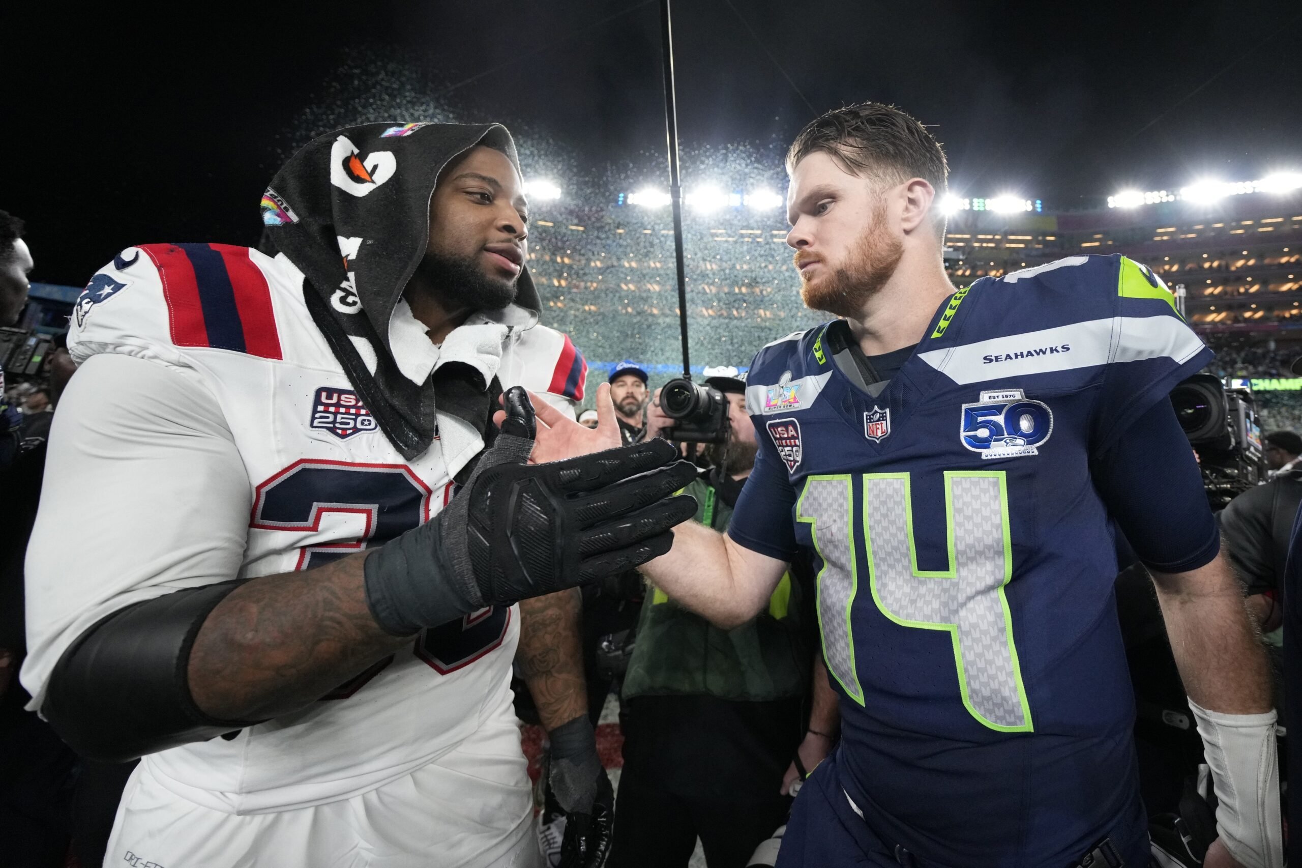 Feb 8, 2026; Santa Clara, CA, USA; Seattle Seahawks quarterback Sam Darnold (14) and New England Patriots linebacker Anfernee Jennings (33) shake hands after Super Bowl LX at Levi's Stadium. Mandatory Credit: Kyle Terada-Imagn Images