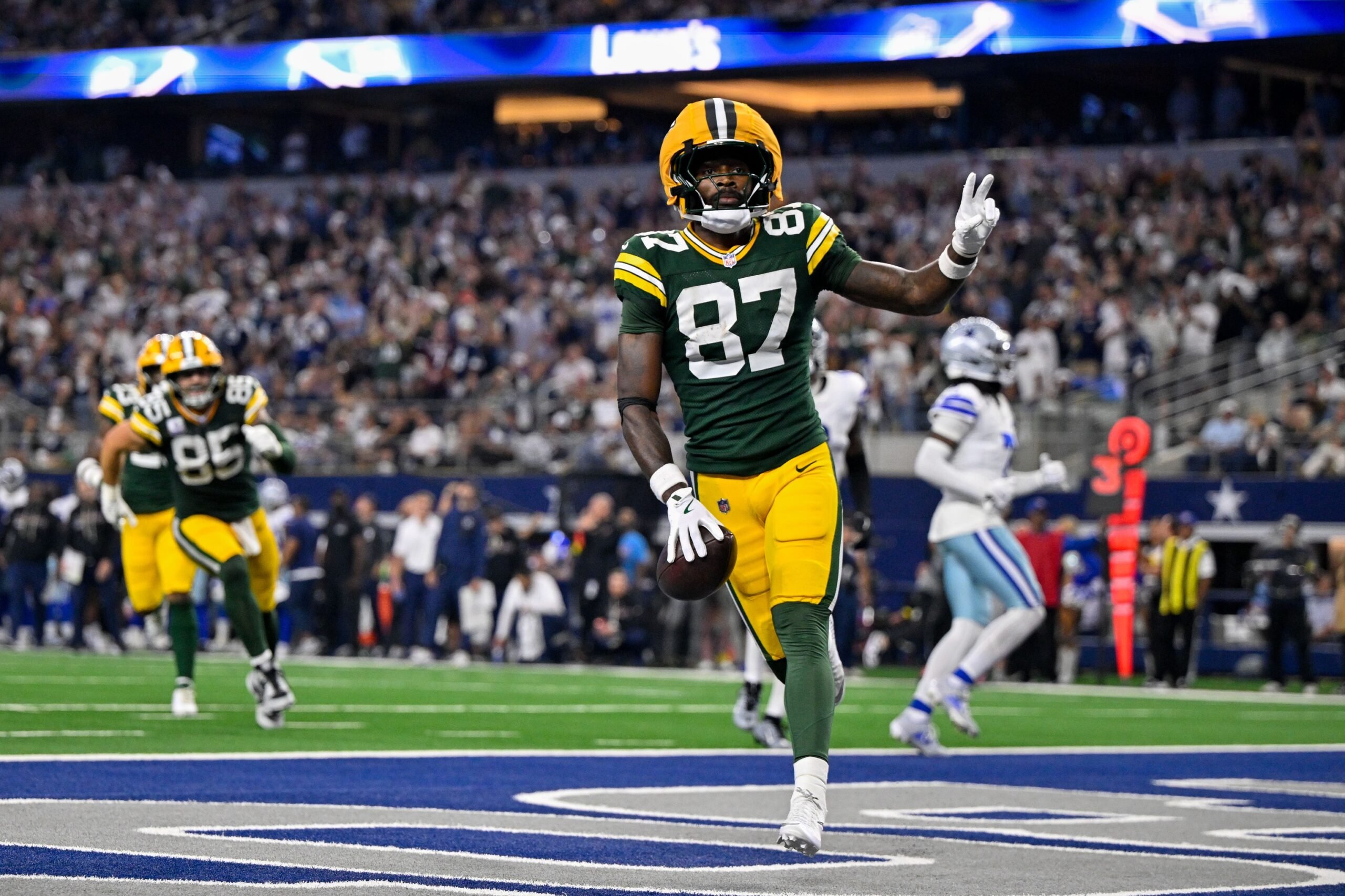 Sep 28, 2025; Arlington, Texas, USA; Green Bay Packers wide receiver Romeo Doubs (87) celebrates in the end zone after he catches a pass for a touchdown during the game between the Dallas Cowboys and the Green Bay Packers at AT&T Stadium. Mandatory Credit: Jerome Miron-Imagn Images