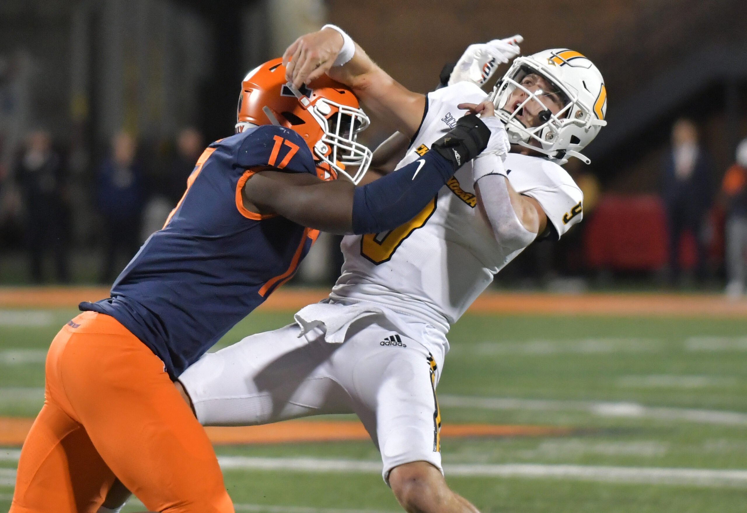 Sep 22, 2022; Champaign, Illinois, USA; Illinois Fighting Illini linebacker Gabe Jacas (17) tackles Chattanooga Mocs quarterback Preston Hutchinson (9) as he passes the ball during the first half at Memorial Stadium. Mandatory Credit: Ron Johnson-USA TODAY Sports