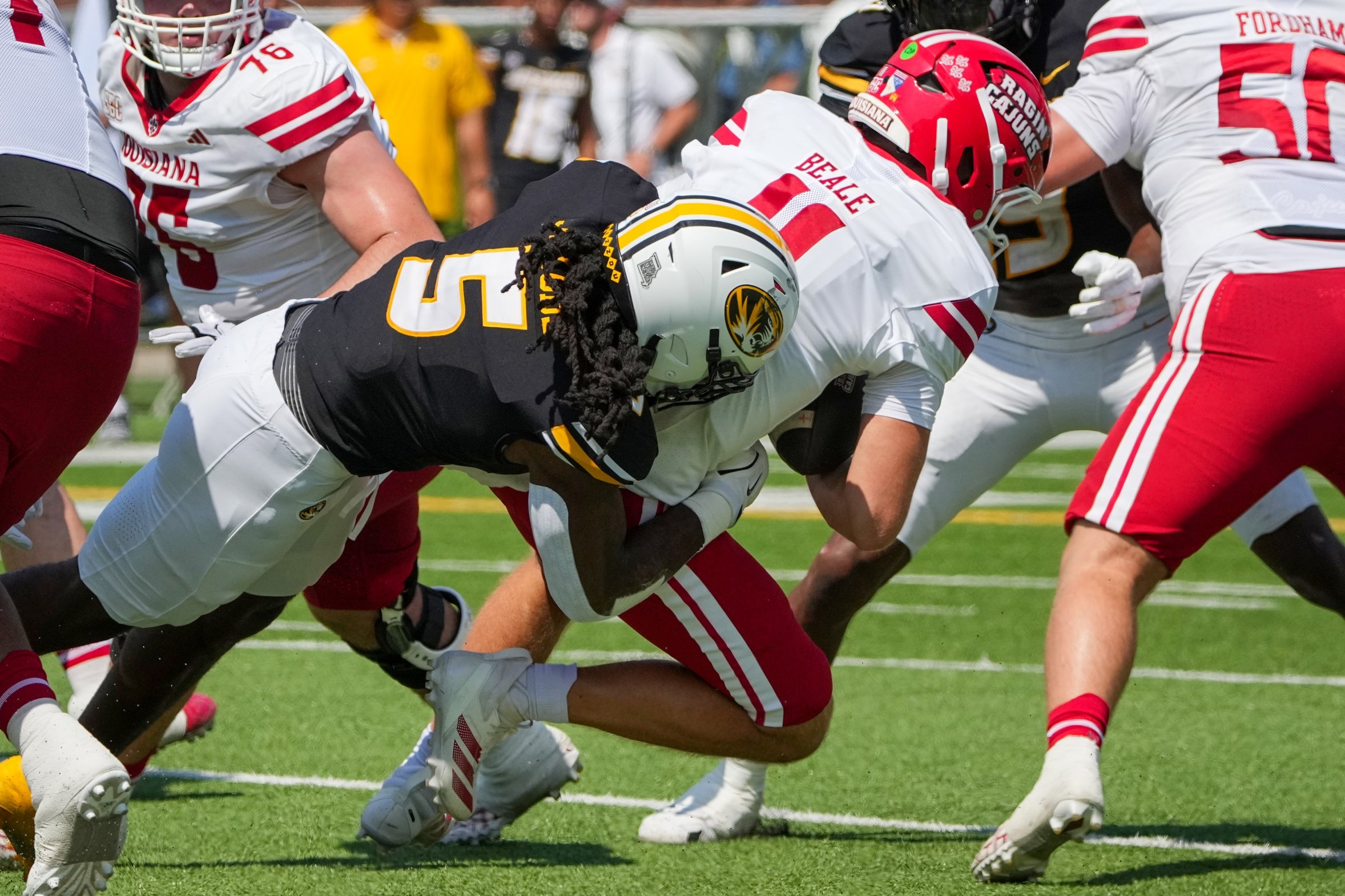 Sep 13, 2025; Columbia, Missouri, USA; Louisiana-Lafayette Ragin Cajuns quarterback Daniel Beale (11) is sacked by Missouri Tigers linebacker Khalil Jacobs (5) during the first half of the game at Faurot Field at Memorial Stadium. Mandatory Credit: Denny Medley-Imagn Images