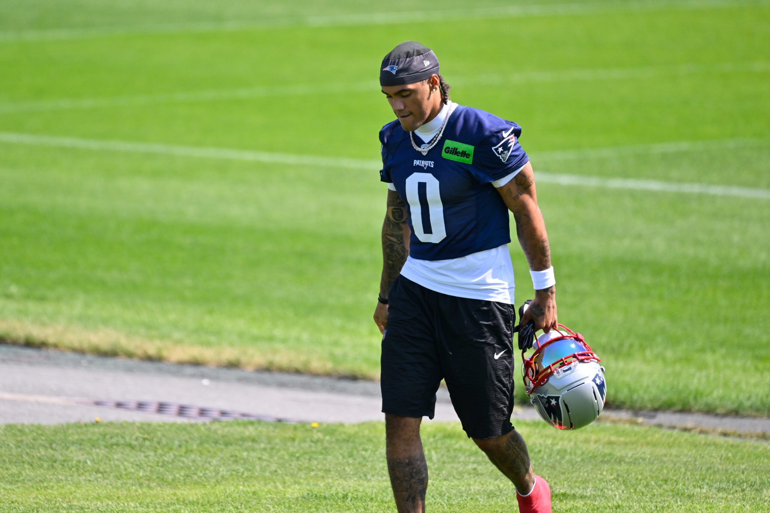 Jul 25, 2026; Foxborough, MA, USA; New England Patriots cornerback Christian Gonzalez (0) walks to the practice fields at training camp at Gillette Stadium. Mandatory Credit: Eric Canha-Imagn Images